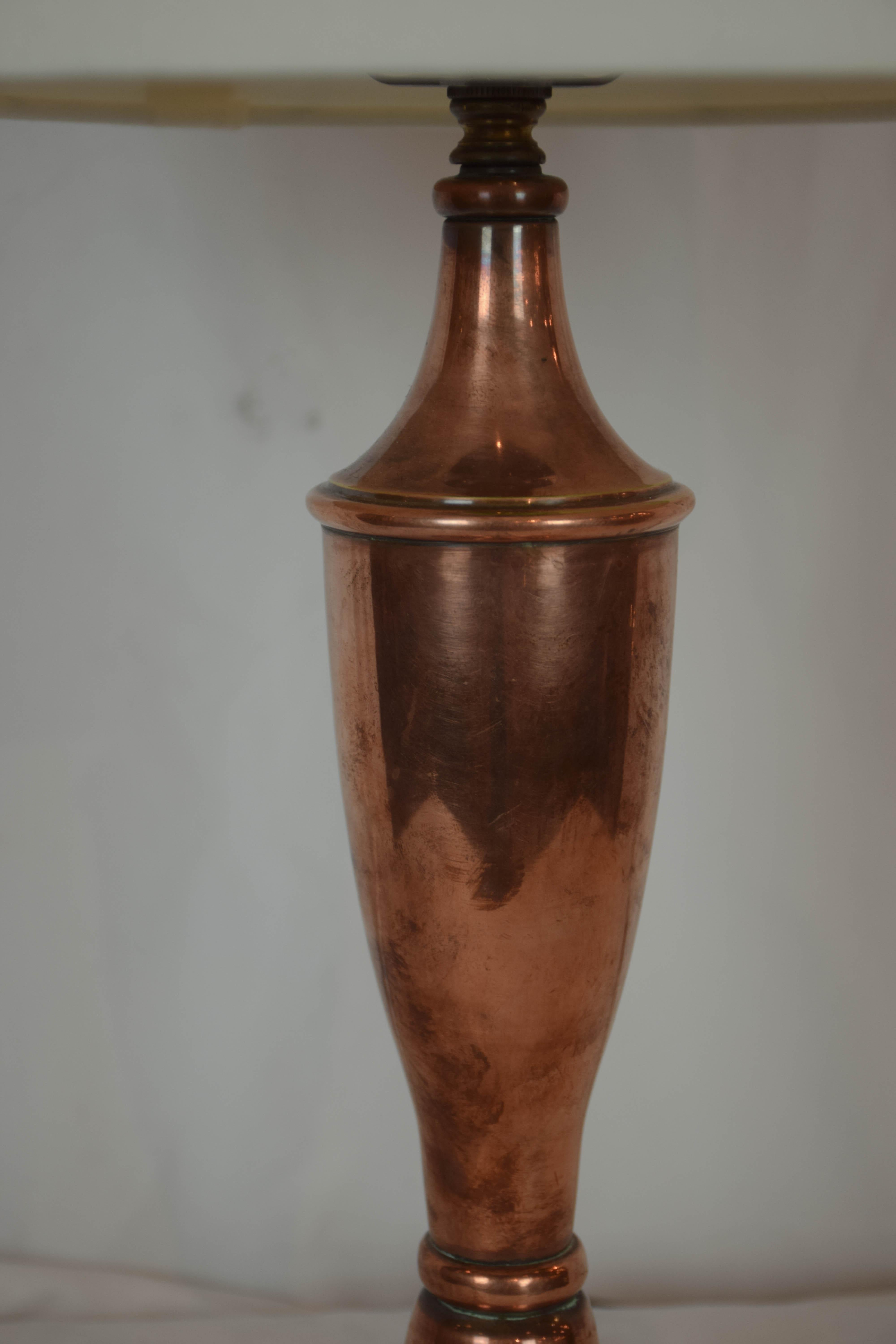This vintage copper table lamp would look great in a kitchen or bar area. The lamp is newly wired to United States standards and features a new paper lined linen shade. The base is weighted for stability. 
Shade dimensions: 8