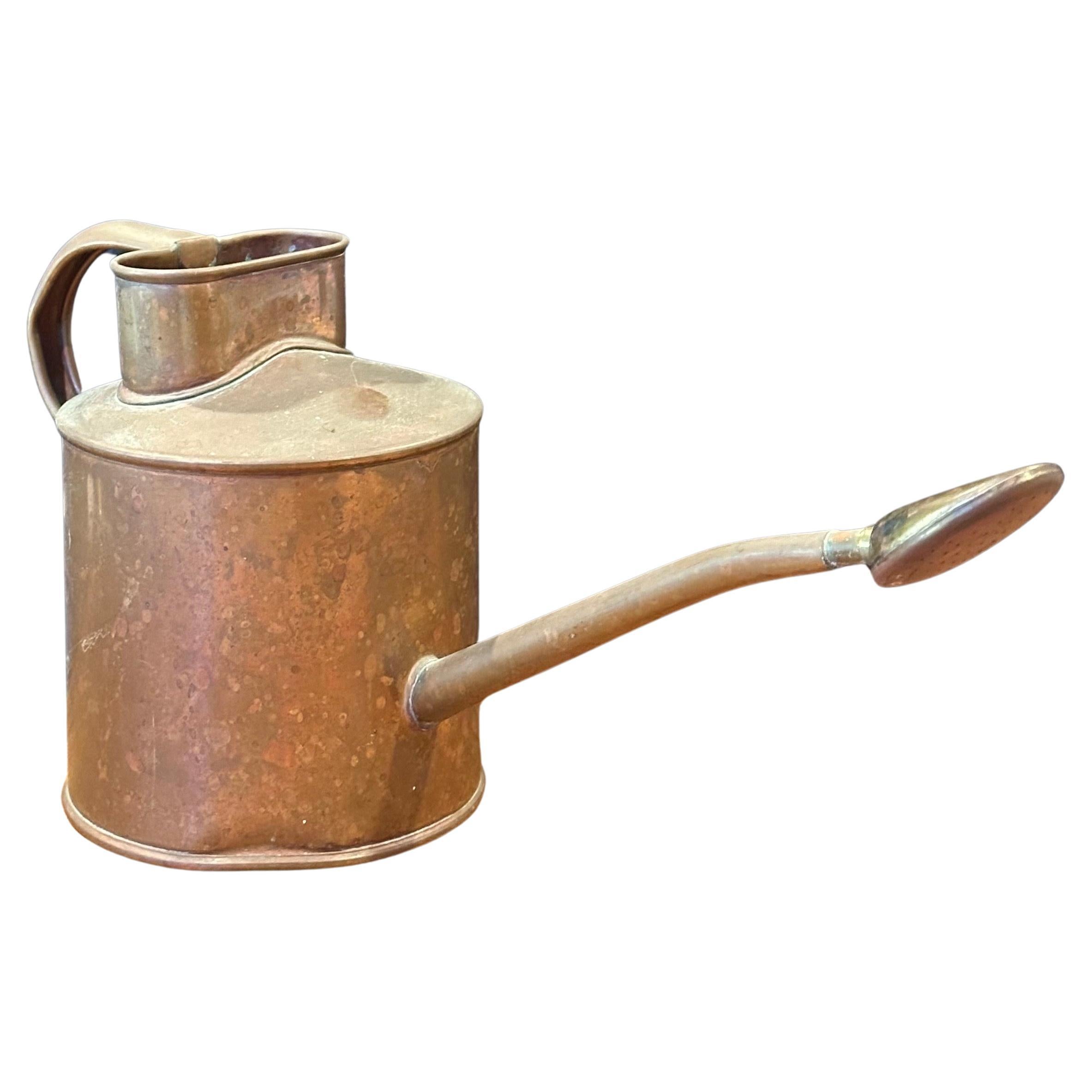 A charming mid-century copper watering can by Brookstone, circa 1990s. The can is in good vintage condition with a removable spout and measures 5.5