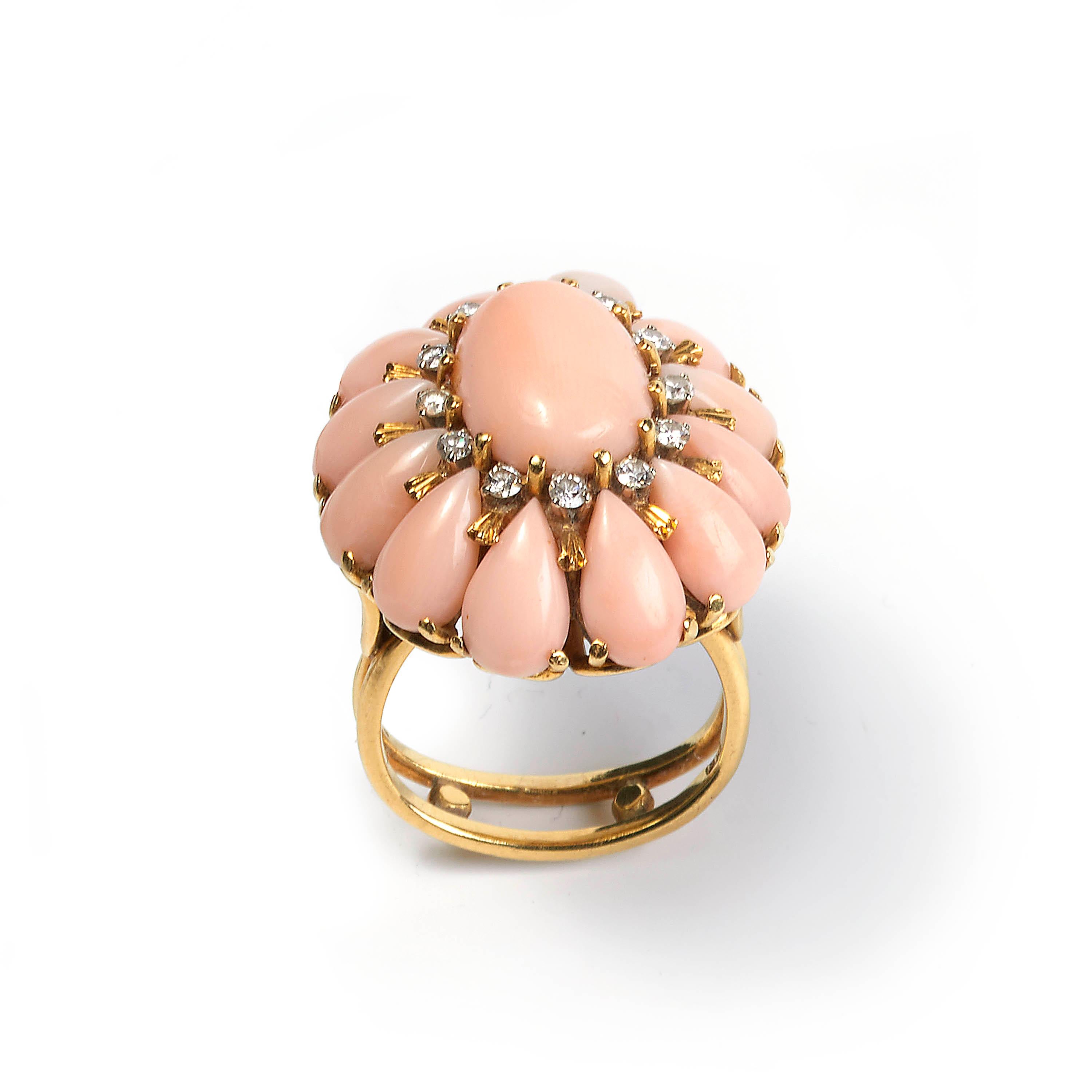A vintage coral and diamond cluster ring, comprised of a central oval cabochon-cut coral, surrounded by twelve round brilliant-cut diamonds, and twelve pear-shaped corals in a cluster formation, mounted in 18ct yellow gold, Italian, circa 1970.

The