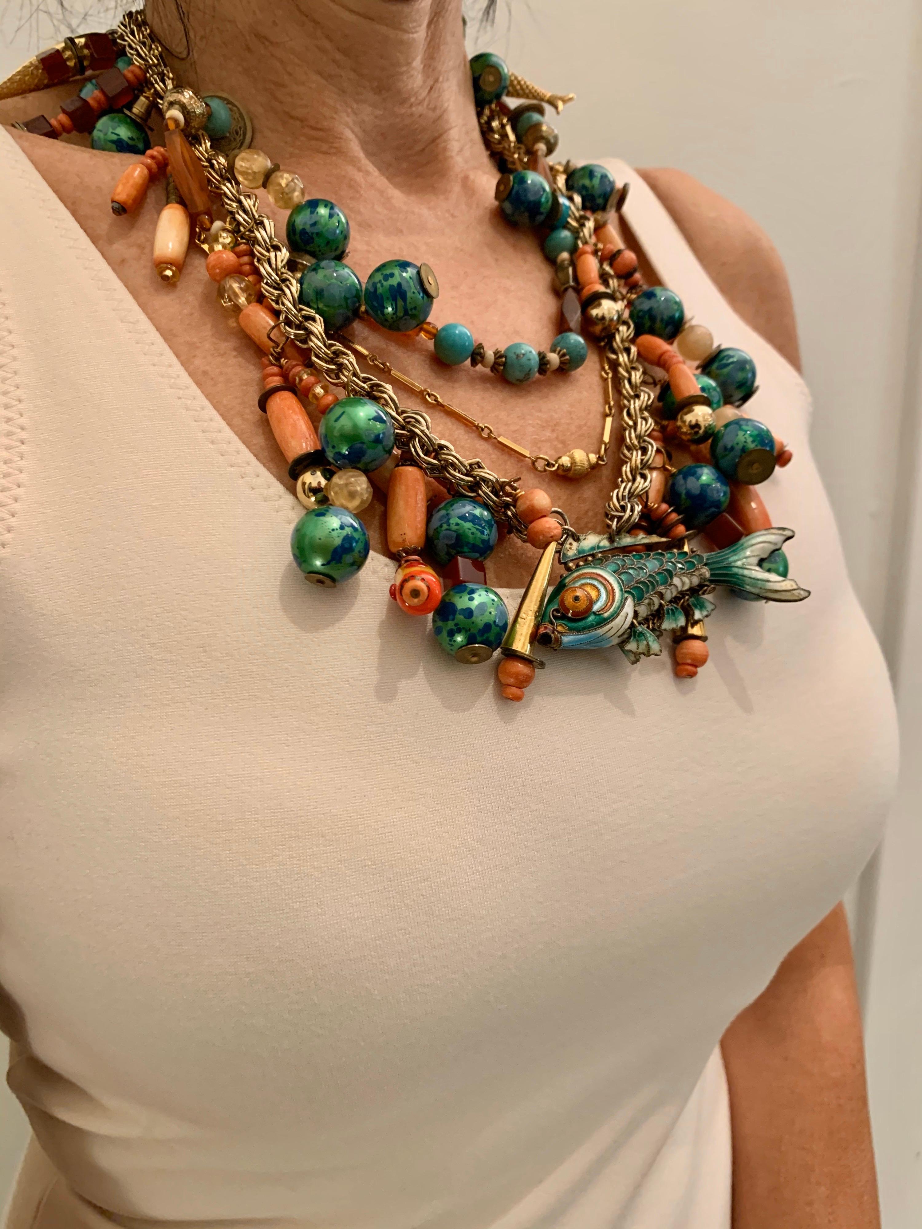 Vintage raw carnelian, coral, and turquoise beaded articulated cloisonne enamel koi fish pendant necklace. The statement necklace is comprised of three mixed gilt chains 
 which are intricately beaded and covered with antique Chinese coins,