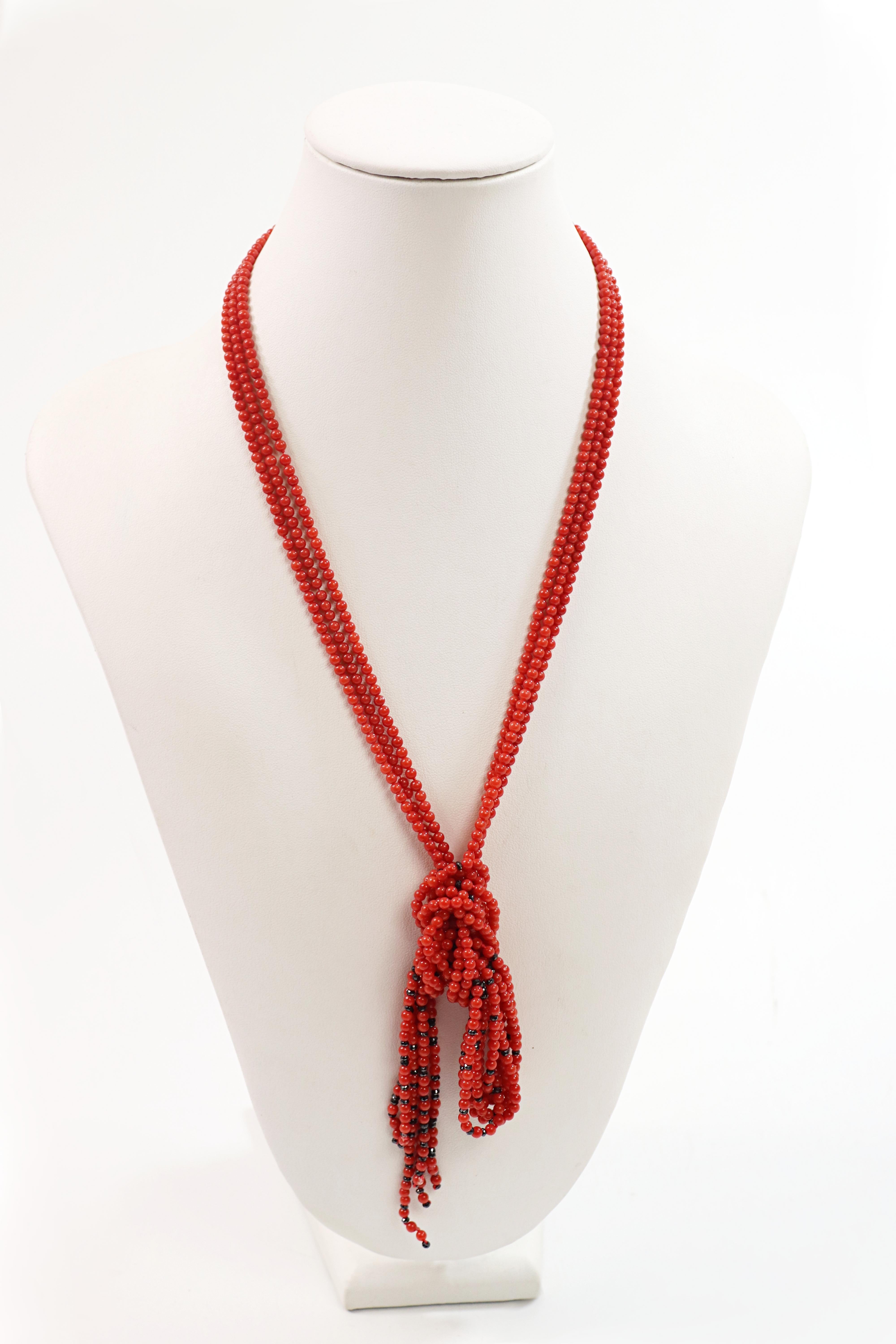 Composed of numerous 3.00 mm, red coral beads, accented by several,
2.3 mm, black onyx faceted beads, completed by an 18k yellow gold 10 X
1.3 X 2.9 mm, connecting stay, forming a three-strand 24 inch sautoir
necklace, Total Weight 57.52 grams.