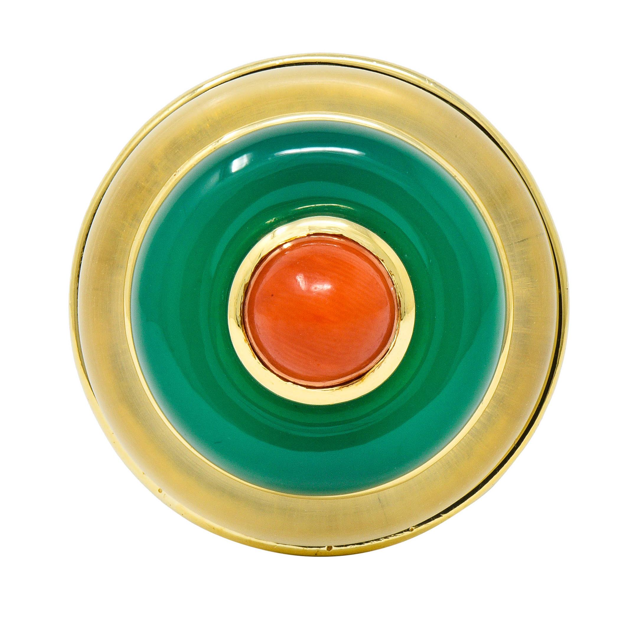  Statement ring is designed with three tiers of concentric circles comprised of coral, chrysoprase, and rock crystal

Centering a 7.6 mm round coral cabochon with bright reddish-orange color

Surrounded by a carved ring of chrysoprase, translucent