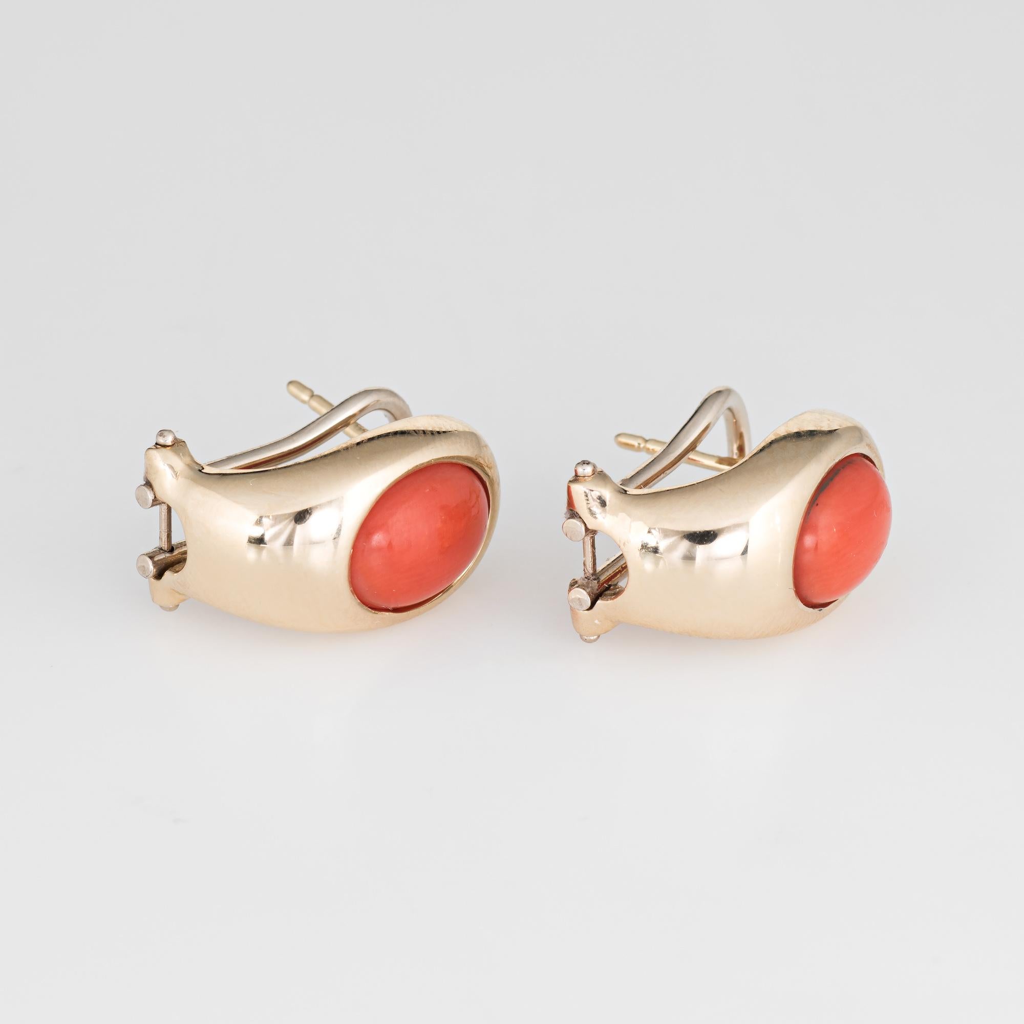 Elegant pair of vintage coral earrings crafted in 14k yellow gold. 

Cabochon cut coral measures 9mm x 6.5mm (estimated at 1.75 carats each - 3.50 carats total estimated weight). The coral is in excellent condition and free of cracks or chips. 

The