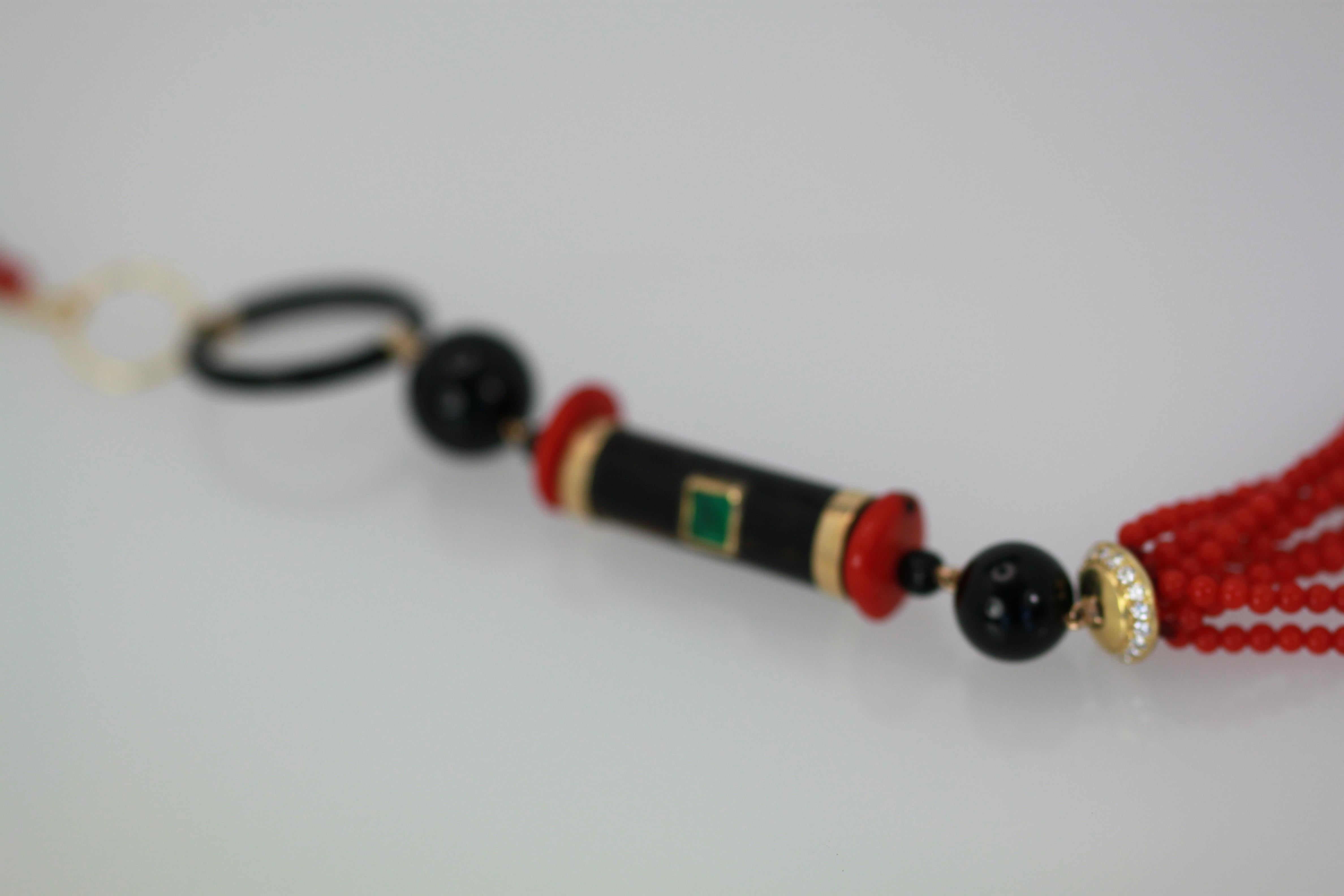 This multi gem Tassel Pendant Necklace is set in 18K Yellow Gold and features a gorgeous rich Emerald green stone set into a bezel set in black Coral topped with yellow gold bands.  The Black Coral cylinder is topped with Coral wafer beads and 2