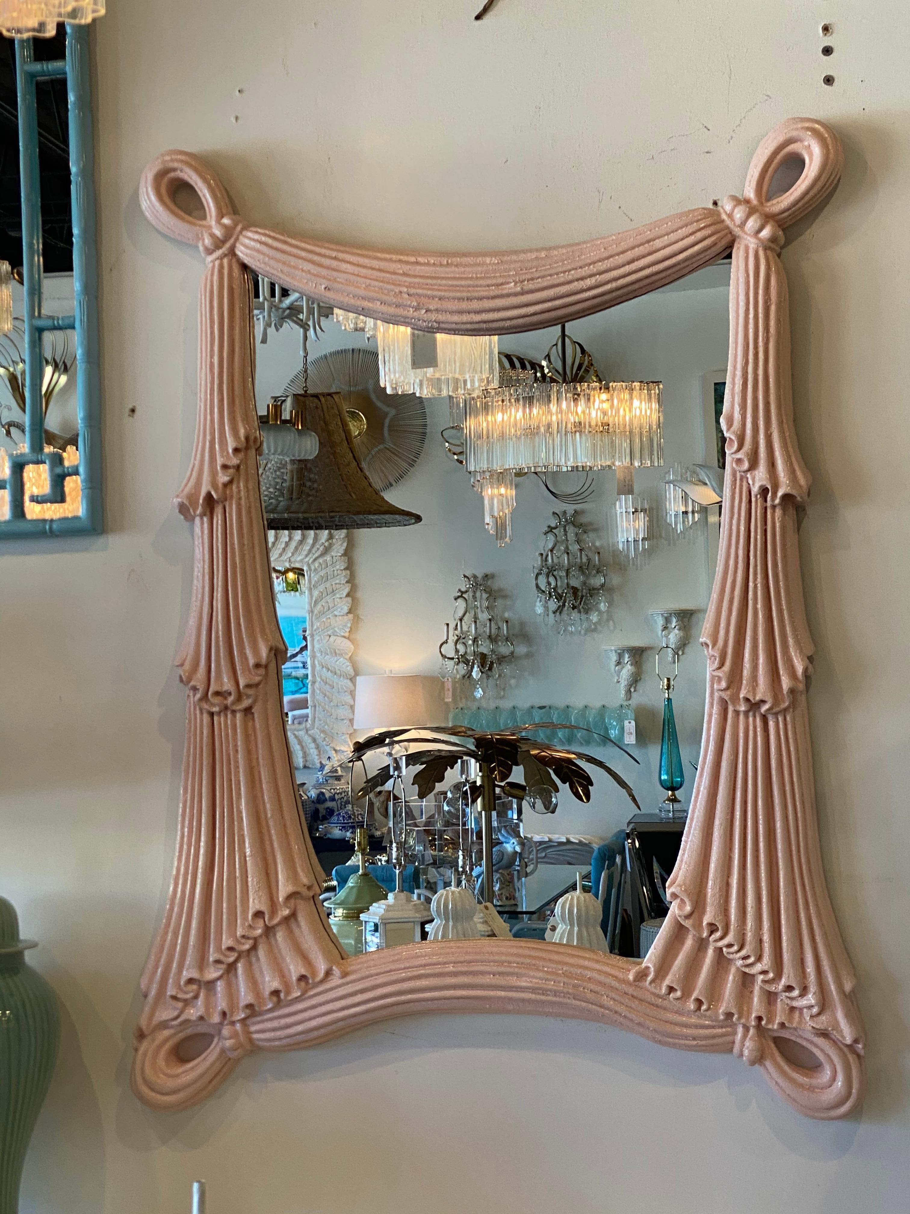 Vintage large wall mirror, lacquered in a peach coral color. Draped swag details make this mirror extra special! Made of a composite. Ready to hang.
