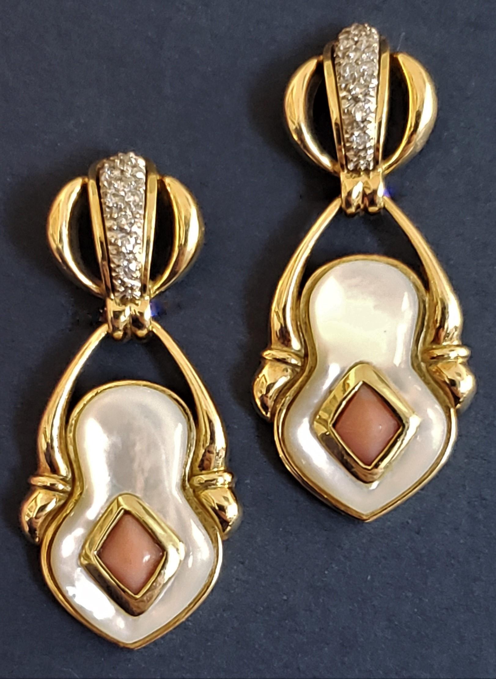 Each earring encrusted with 9 diamonds (G-H color VS-SI1 in clarity, clean and sparkly stones. Diamonds set into white gold). Dangling part of each earring set with natural coral (bezel set into yellow gold) into white Mother of Pearl artfully