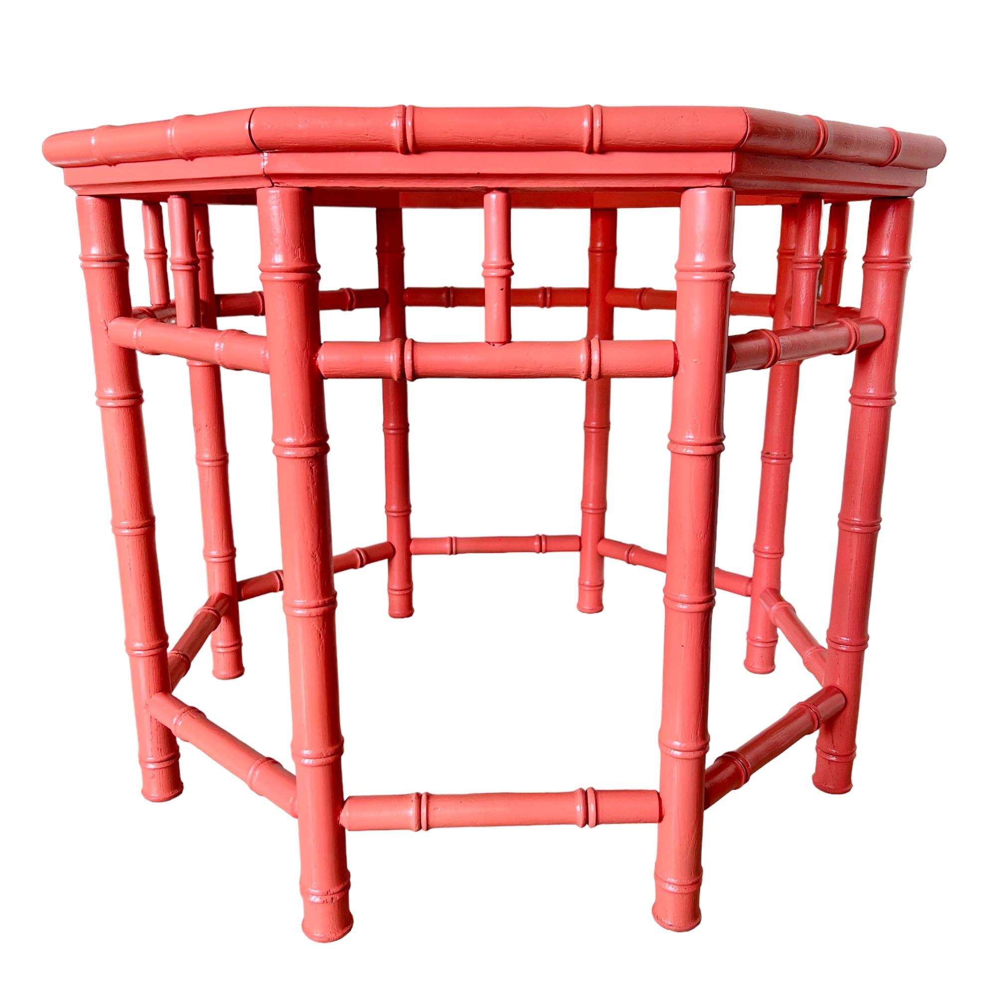 This vintage newly painted wood octagon accent table features an inset smoked glass top bordered by a stacked beveled edge above a doweled showcase apron and eight legs connected by stretchers. Its Palm Beach regency style is accentuated with turned