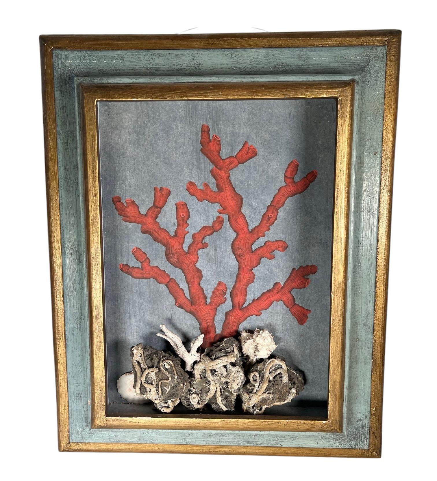 A pair of coral paintings in shadowbox with real seashells. Beautifully framed with a pale blue backdrop and an aqua and gold wood frame. 