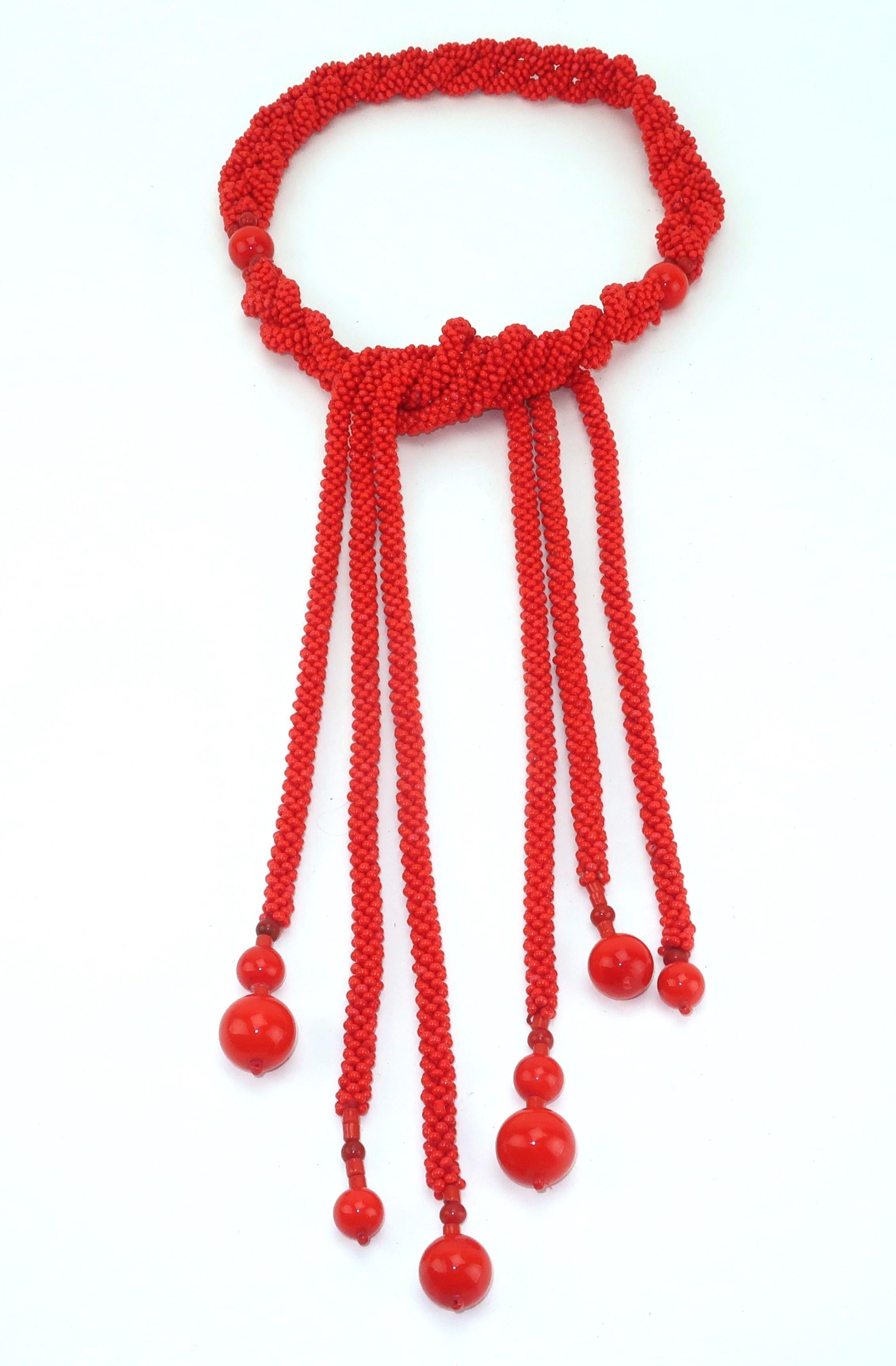 Vintage glass bead braid belt in a bright shade reminiscent of red coral.  The belt can be looped at the waist for an exotic bohemian look.  It can also be worn as a lariat style necklace.  No maker's mark though beautifully made.  From the Atlanta
