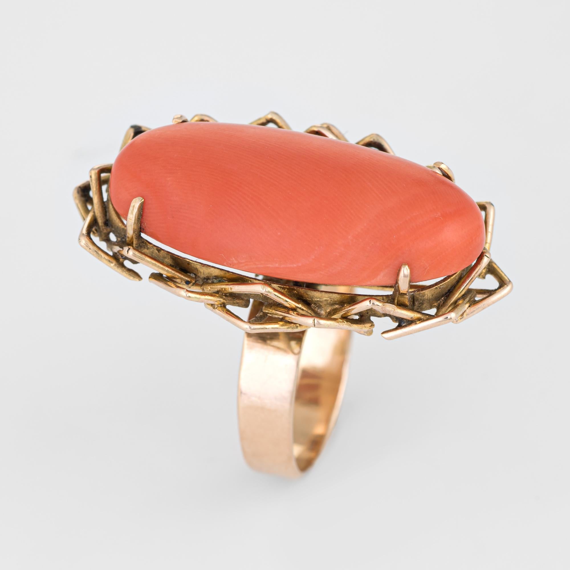 Stylish vintage coral cocktail ring (circa 1960s to 1970s) crafted in 18 karat yellow gold. 

Coral measures 30mm x 15mm and is estimated at 35 carats. The coral is in excellent condition and free of cracks or chips. 

The large piece of coral is