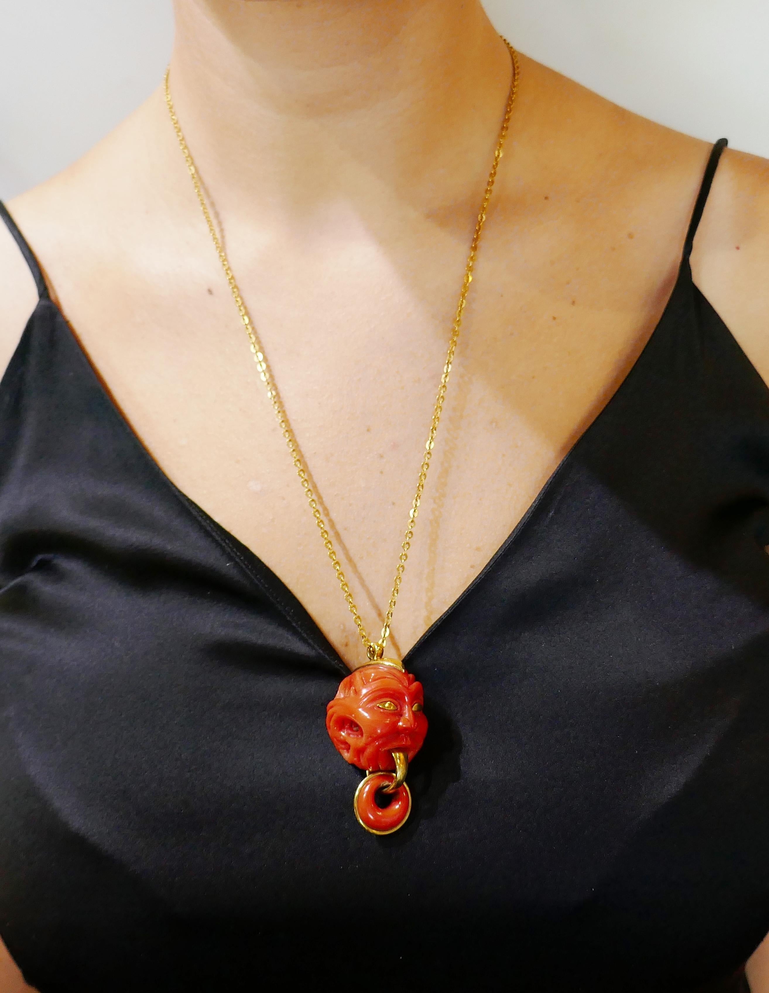 Fun and unusual coral pendant that is definitely a conversational piece. 
The pendant is made of carved Mediterranean coral and 14 karat (tested) yellow gold. It measures 2 x 1 x 1-1/8 inches (5 x 2.5 x 2.8 cm) with the bail. The chain is made of 18