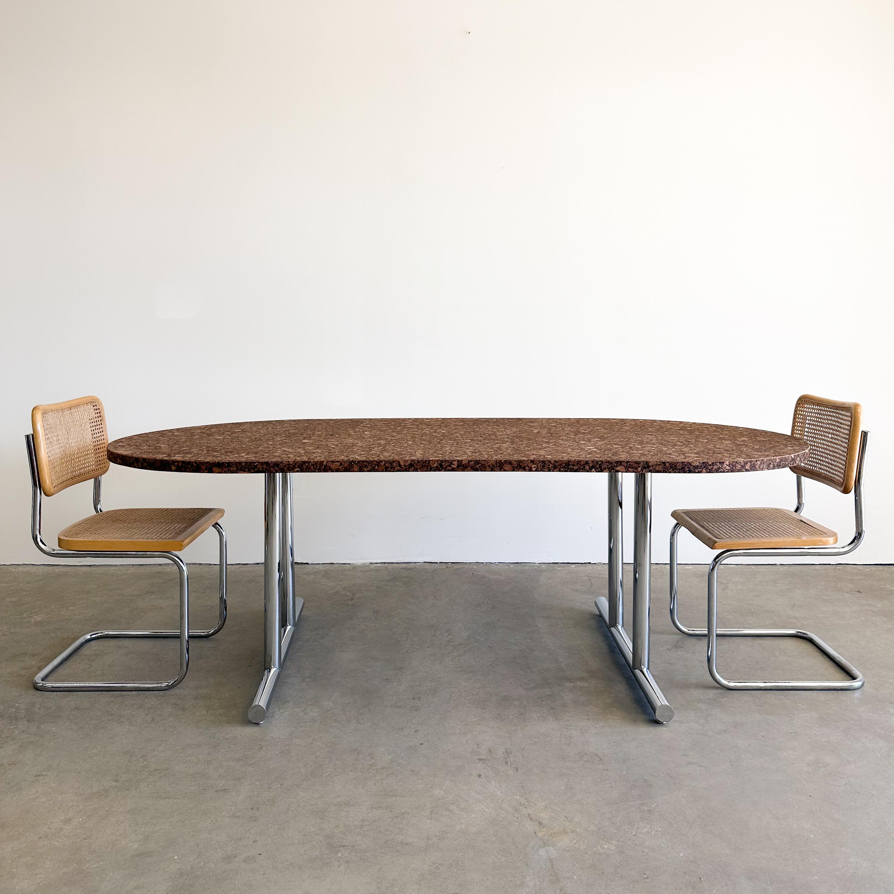 Vintage Oval Cork Dining Table.

This table can serve multiple purposes. It can be used as a conference table for professional meetings, offering a distinct and creative aesthetic, or it can function as a dining table for your home, allowing you to