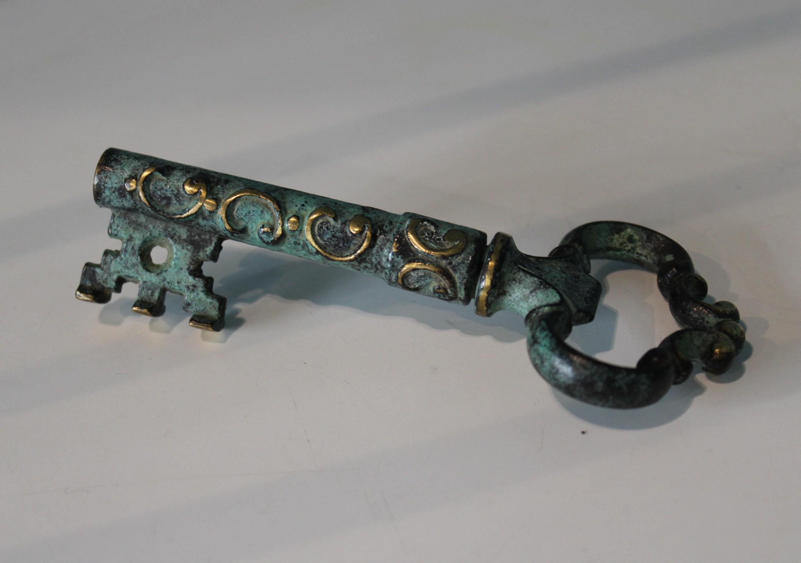 Vintage corkscrew and bottle opener, key shape.
