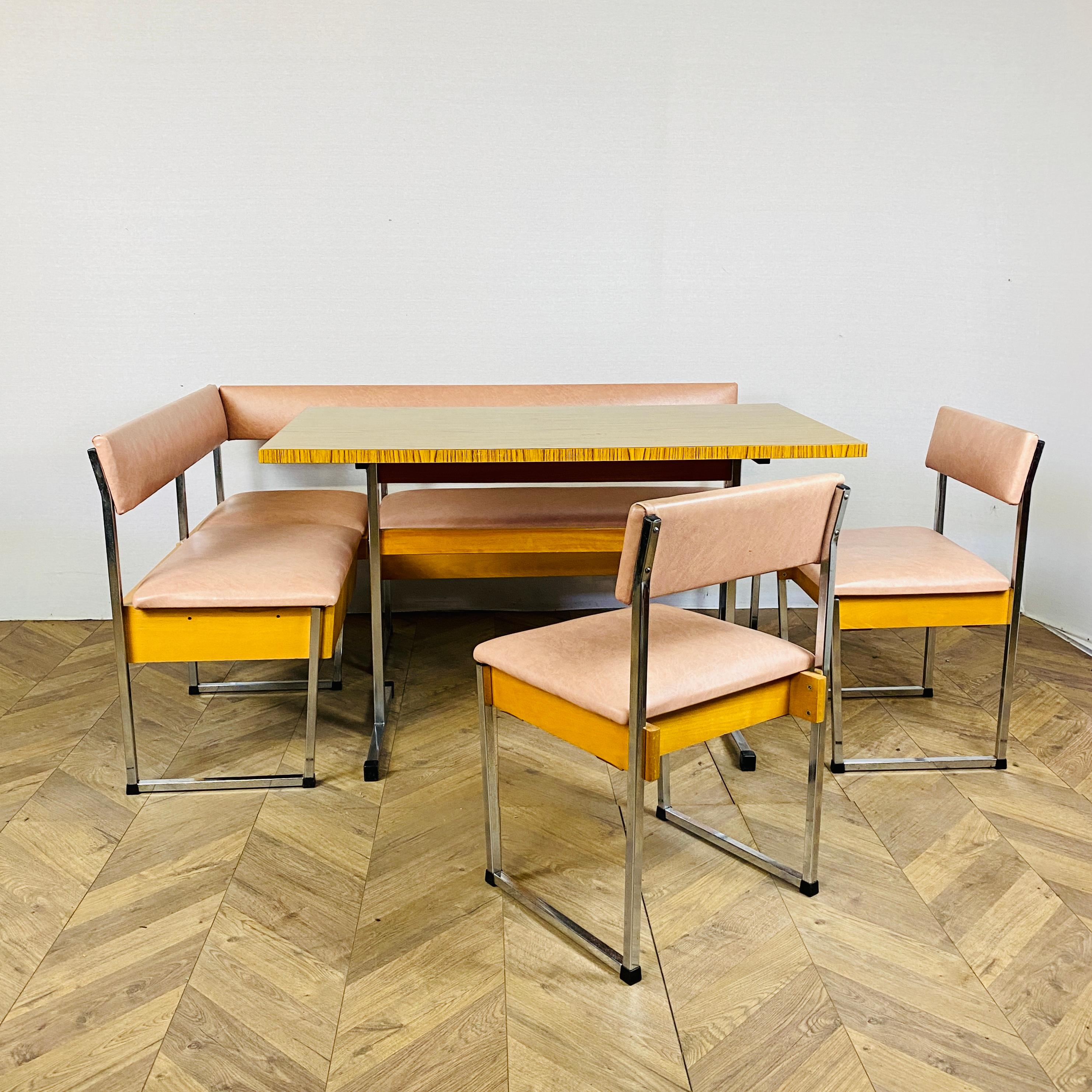 Vintage corner dining set, which includes a dining table, a banquette corner seat and 2 dining chairs, circa late 1960s / early 1970s.

The set features chrome legs throughout and soft pink vinyl upholstery, both of which are in great