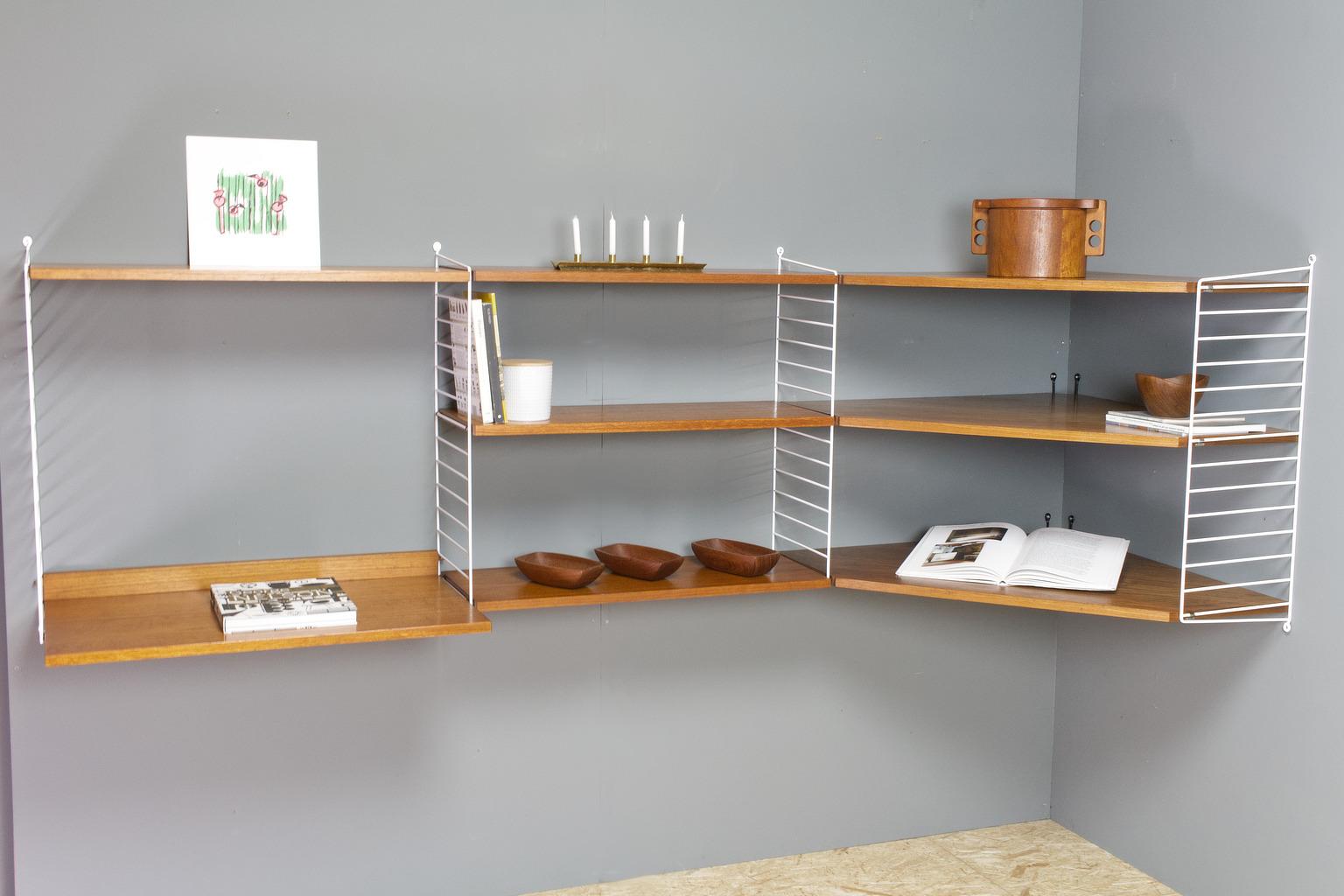 Vintage string modular wall unit, 1960s. Corner modular system, with additional deeper desk shelf. Larger unit with label present. White brackets in good condition, teak shelves are intact in very nice vintage condition. Some traces of use as can be