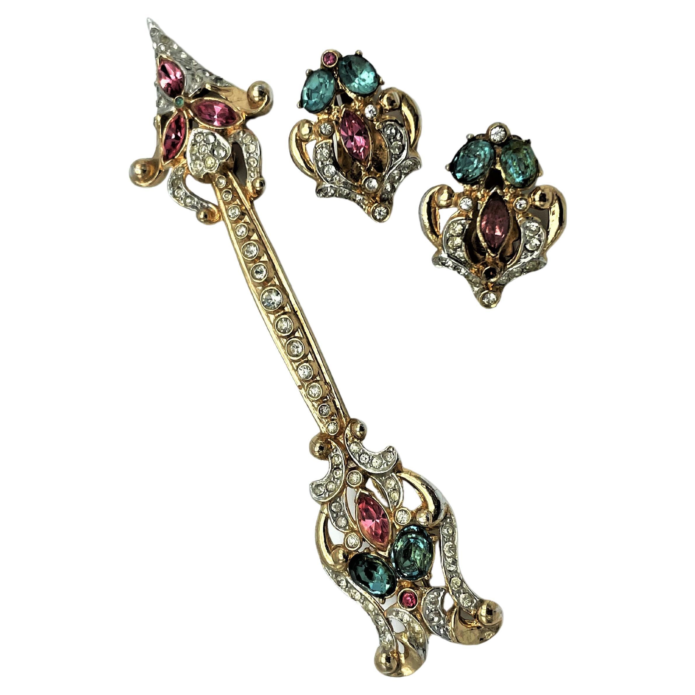 A feminine set, consisting of the whistle brooch with pink and light blue rhinestones, with matching ear clips, designed by CORO USA.  
MARKS OF QUALITY
For the most part, pieces marked 