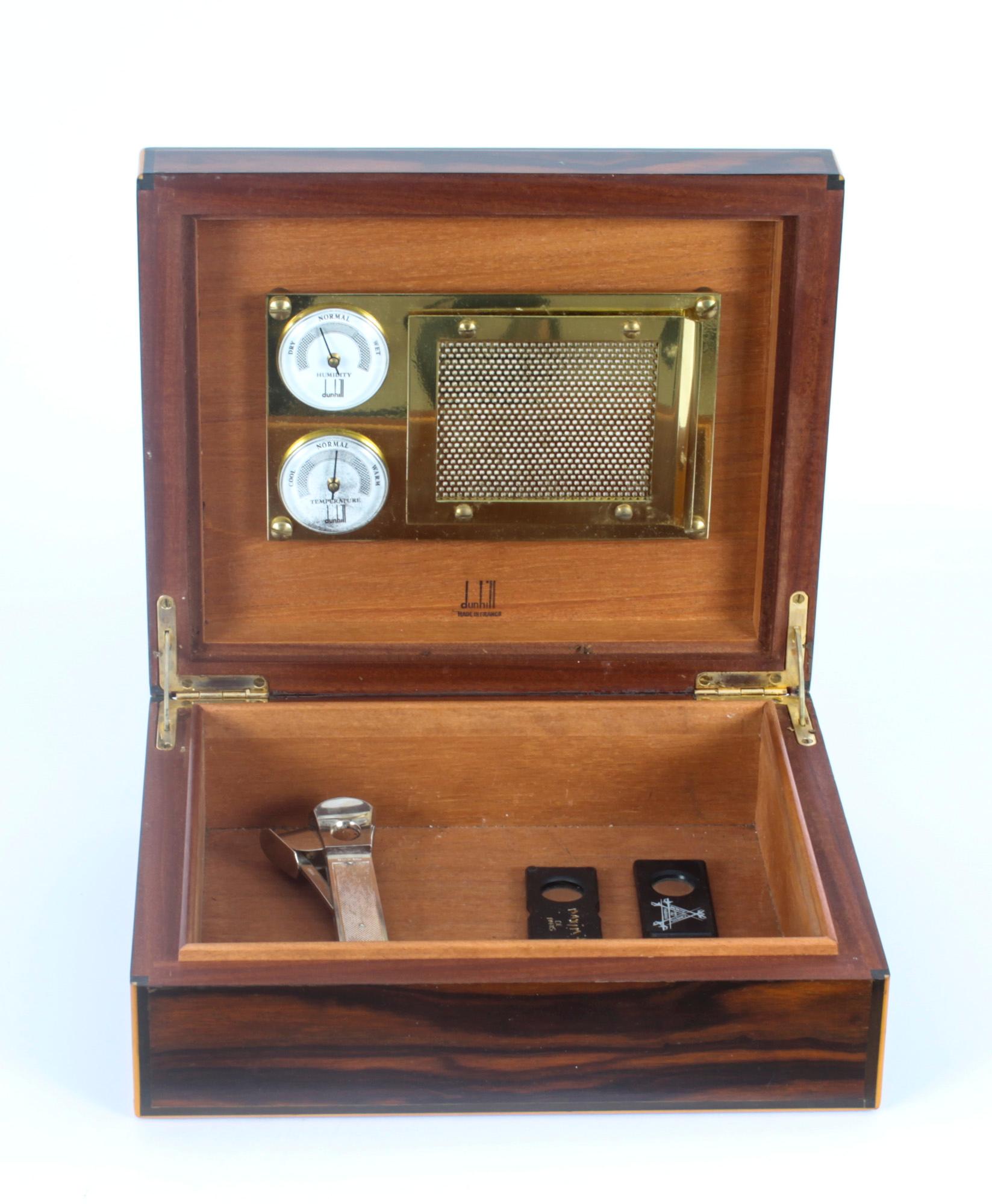 A Dunhill France, coromandel and boxwood strung cased cigar humidor, together with a sterling silver cigar cutter, dating from the second hald of the 20th Century.

The humidor has a Spanish cedar-lined interior which helps to keep the aroma and