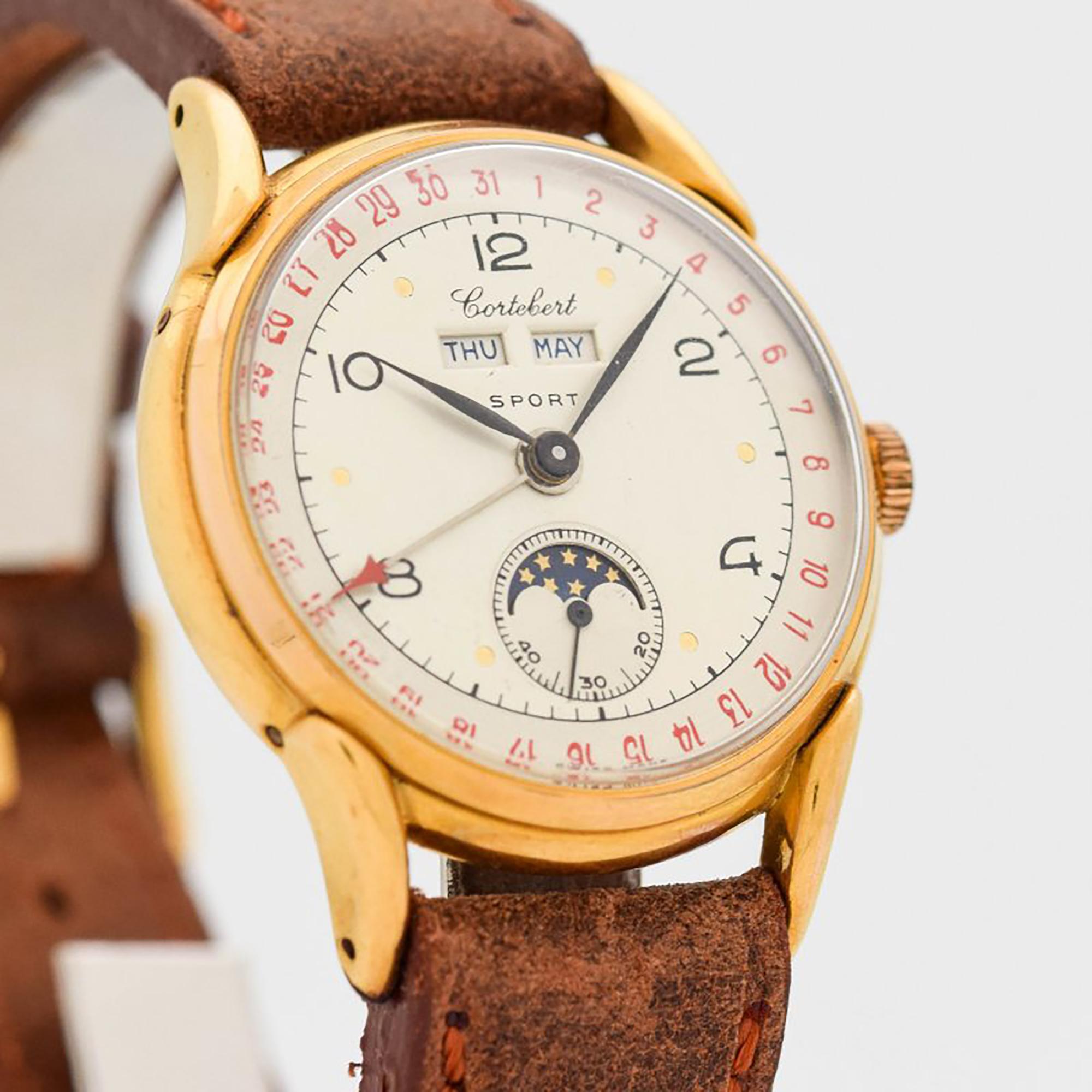1940's Vintage Cortebert Sport Triple Date Moonphase Ref. 9300 18k Yellow Gold Filled and Stainless Steel Case Back watch with Gray and Silver Dial with Black Arabic Numbers and Red Arabic Outer Date Indicator. 36mm x 42mm lug to lug (1.42 in. x