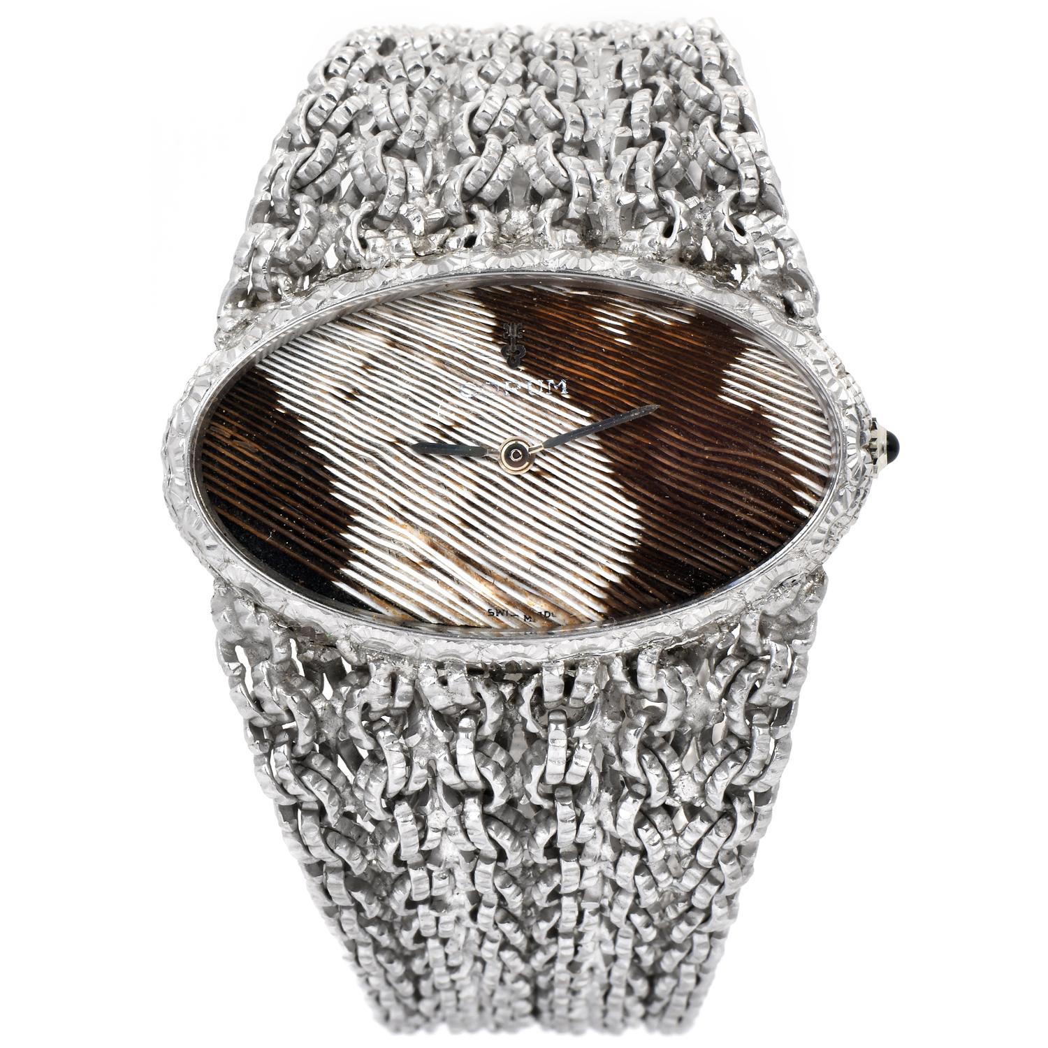 Experience the uniqueness of this Vintage Corum Textured Watch.  

Crafted in solid 18K White Gold, from circa the 1970s, this prominent-looking watch brings an intricate and luxurious look.

 The dial is a genuine peacock feather texture with,