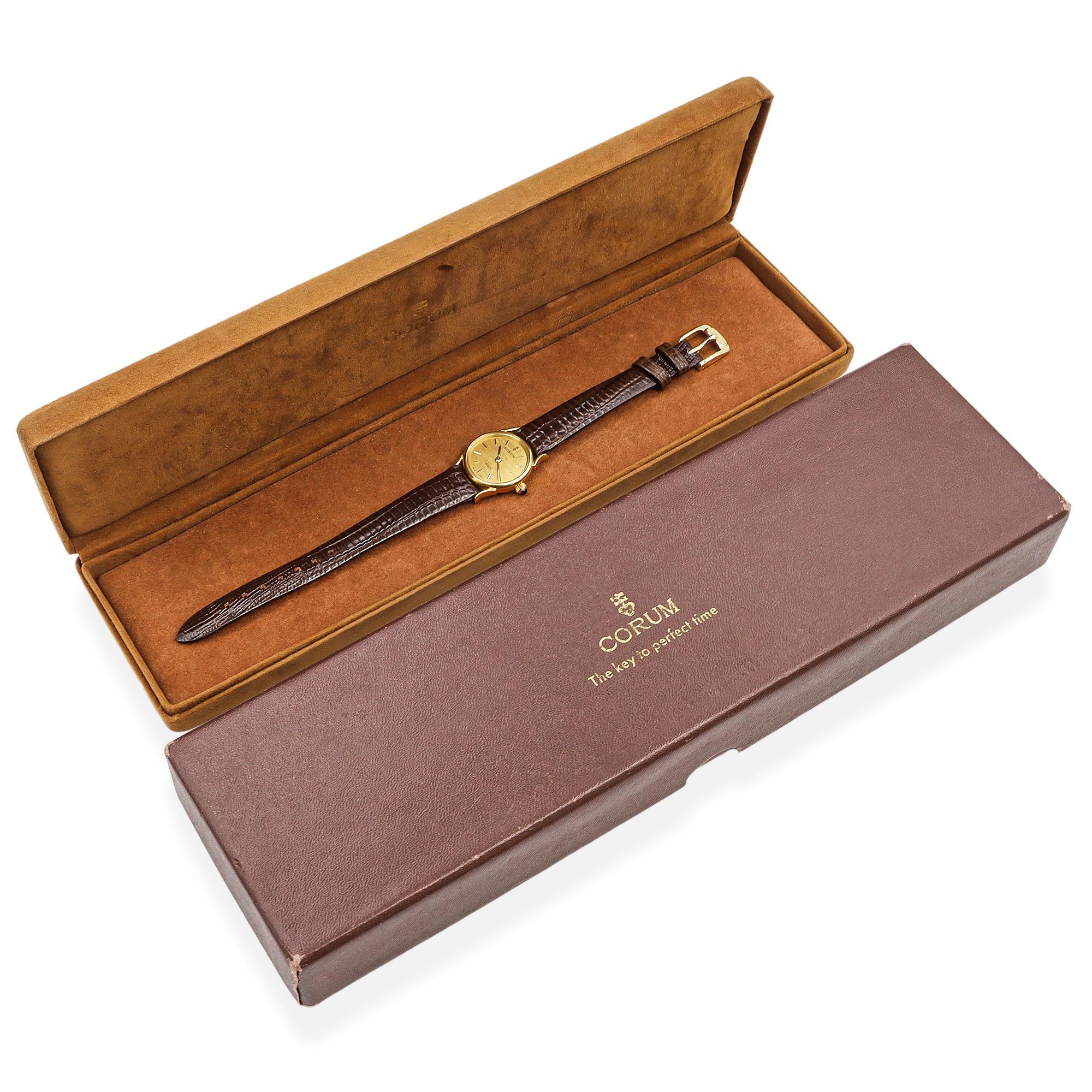This exquisite Corum quartz timepiece is a perfect blend of elegance and precision. Crafted from 18K yellow gold, the watch exudes a warm, luxurious glow, complemented by its finely brushed gold-tone dial. Slim gold indices and dauphine-style hands