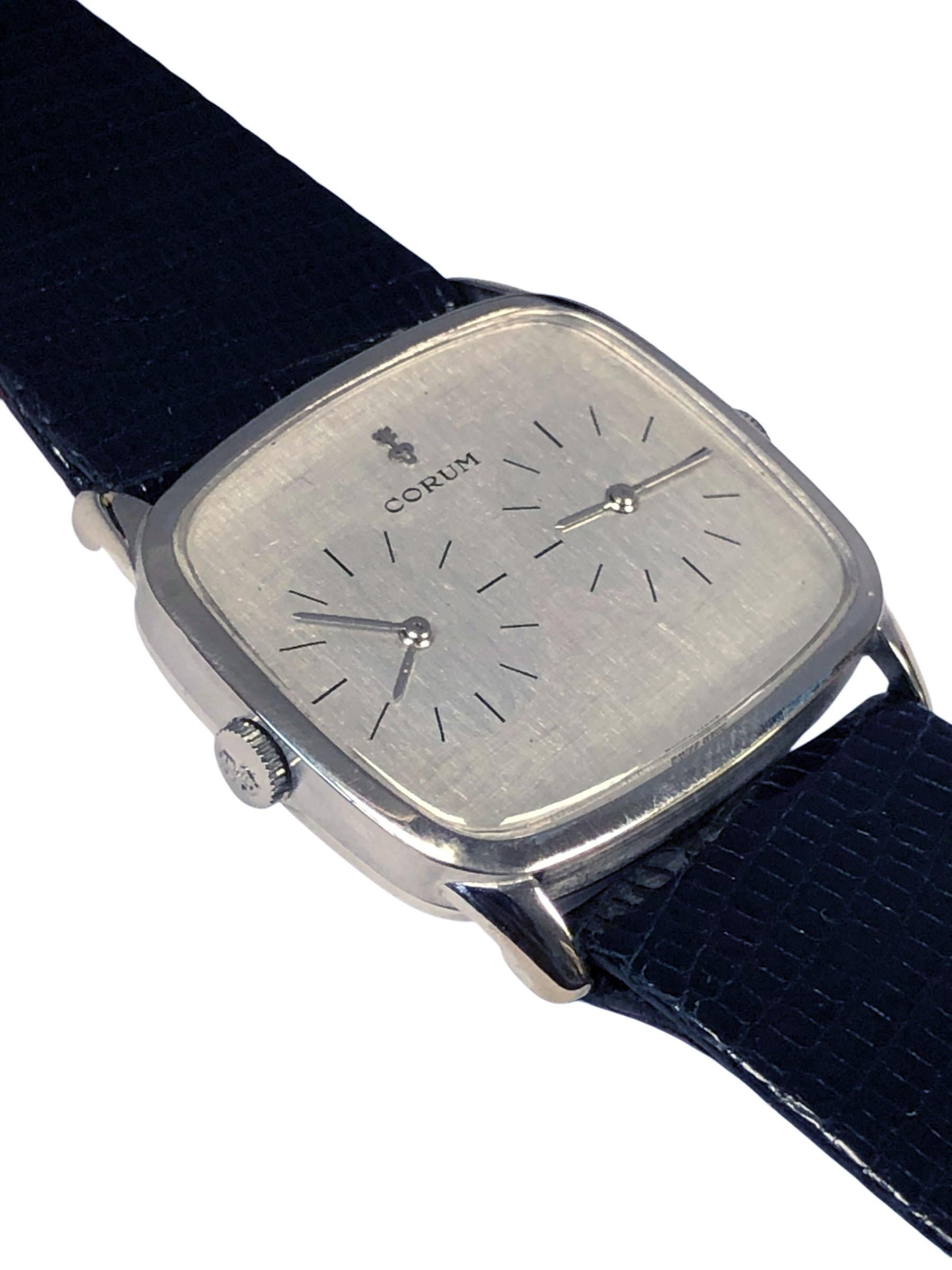 Circa 1970s Corum 2 Time Zone Wrist watch, 33 x 30 M.M 18k White Gold two piece case, two 17 Jewel mechanical, manual wind movements, Silver textured dial. Original Corum Black Lizard strap with original Corum white gold buckle. Wrist size 8 1/4