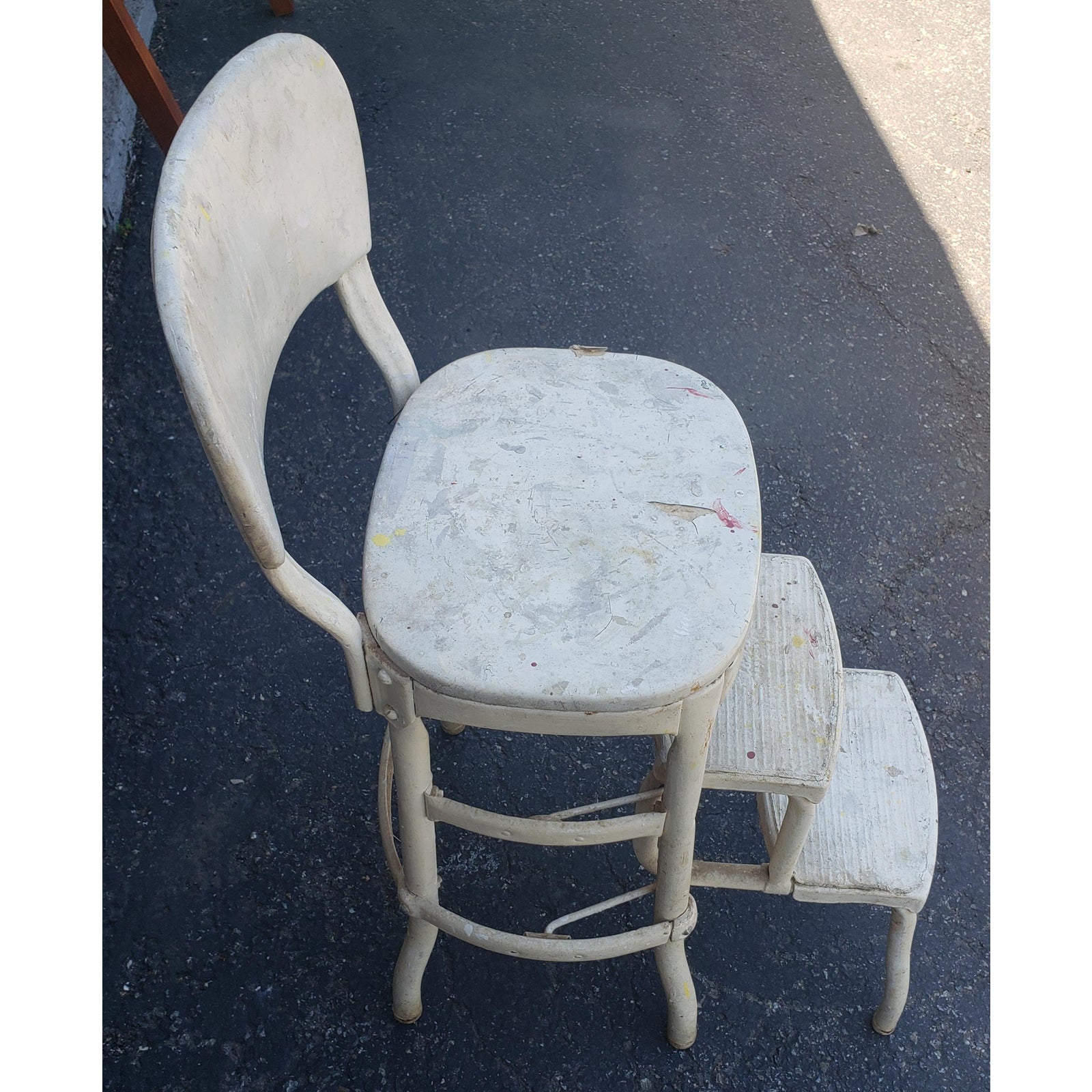 Mid-century antique white Cosco step stool chair. Good condition. The chair steps pull out smoothly as it should and back into place. They need to be cleaned with some steel wool if desired. Antique white vinyl seat and back have some tear and need