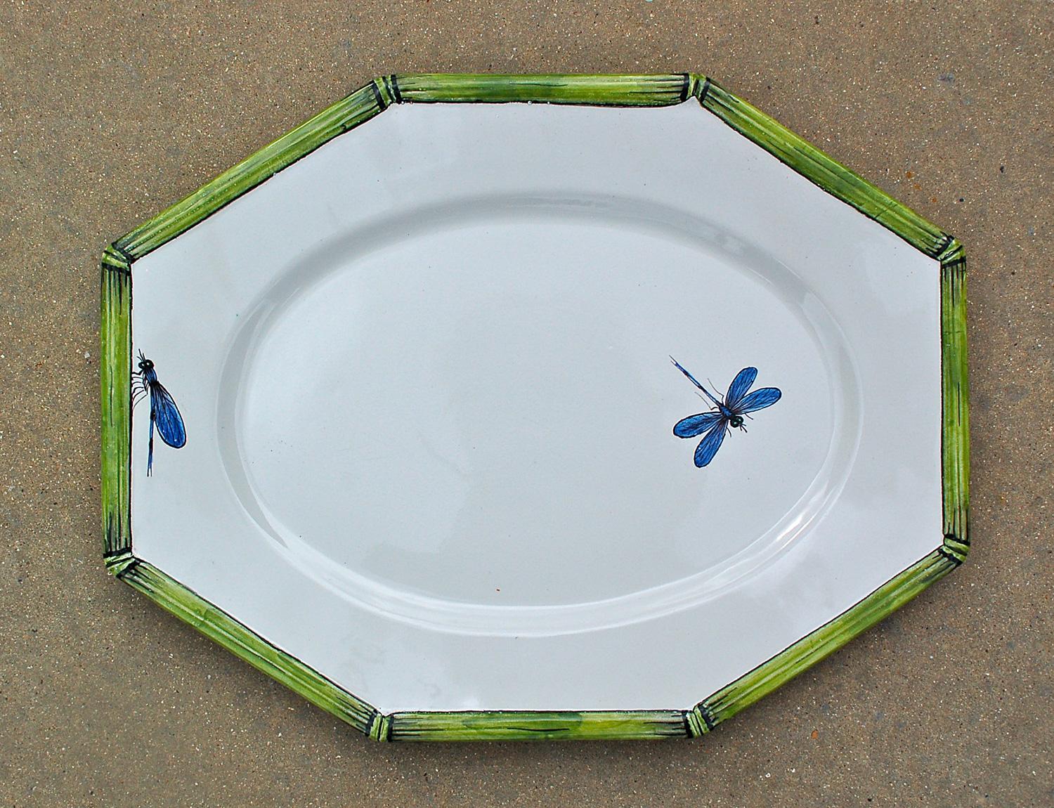 Vintage hand painted Italian pottery serving dish by COSTA with bamboo and dragonfly decoration. The edge or rim is decorated with a green, hand painted, raised bamboo motif. A hand painted blue dragonfly with either its wings open or closed is