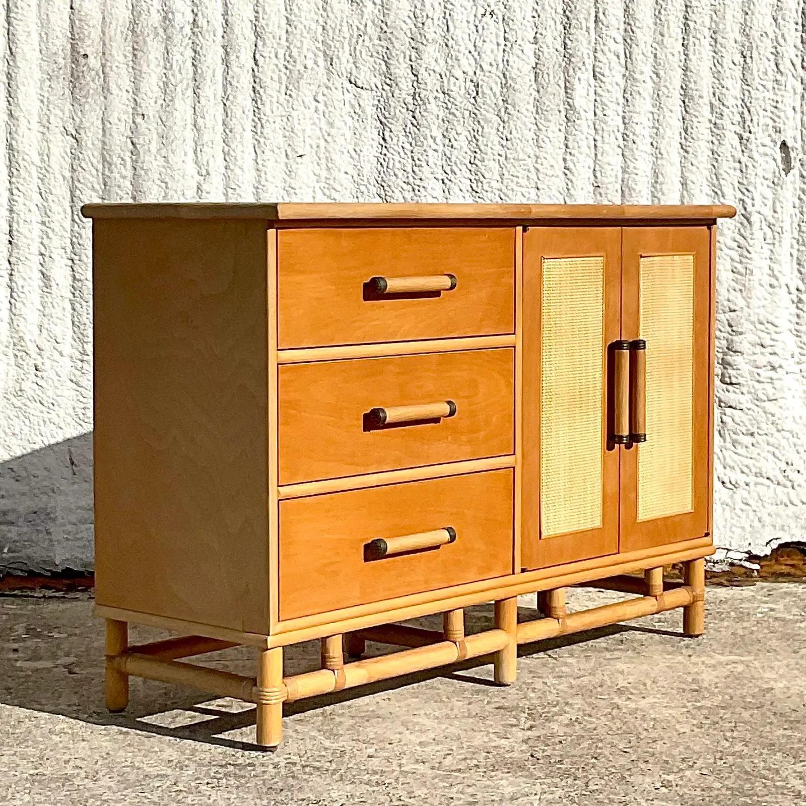 A fabulous vintage Costal sideboard. Beautiful vintage wood cabinet with dip cane front doors and bamboo pulls. A great little beautiful., yet functional piece. Acquired from a Palm Beach estate.