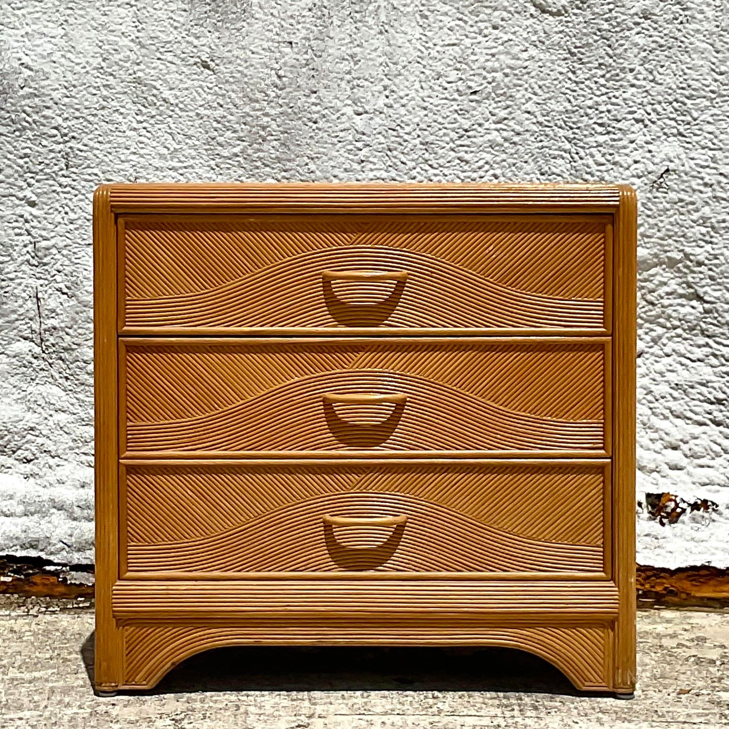 Fantastic vintage Coastal chest of drawers. Fabulous pencil reed frame with a chic wave design on the drawer fronts. Acquired from a Palm Beach estate.