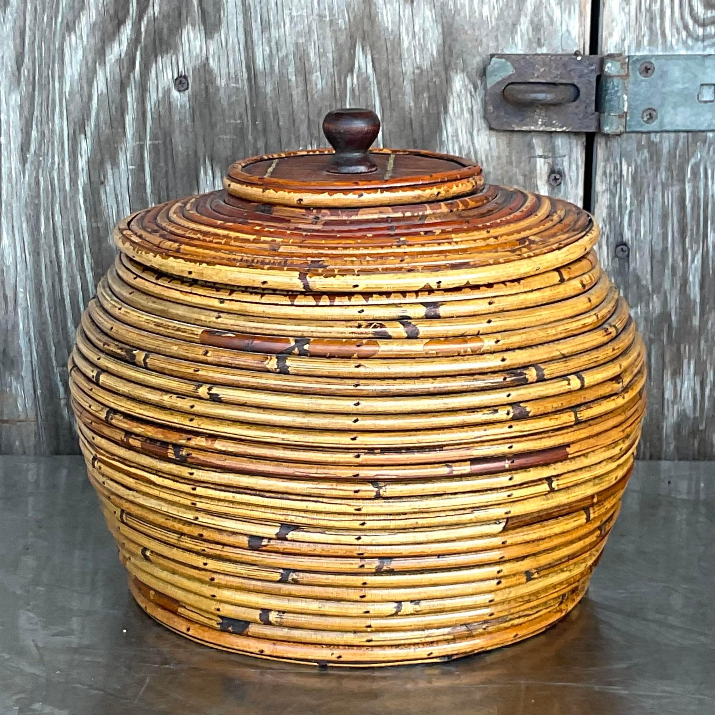 A fabulous vintage Coastal lidded urn. A chic coiled pencil reed in warm brown tone. Coordinating tall urn also available on my Chairish page. Acquired from a Palm Beach estate.