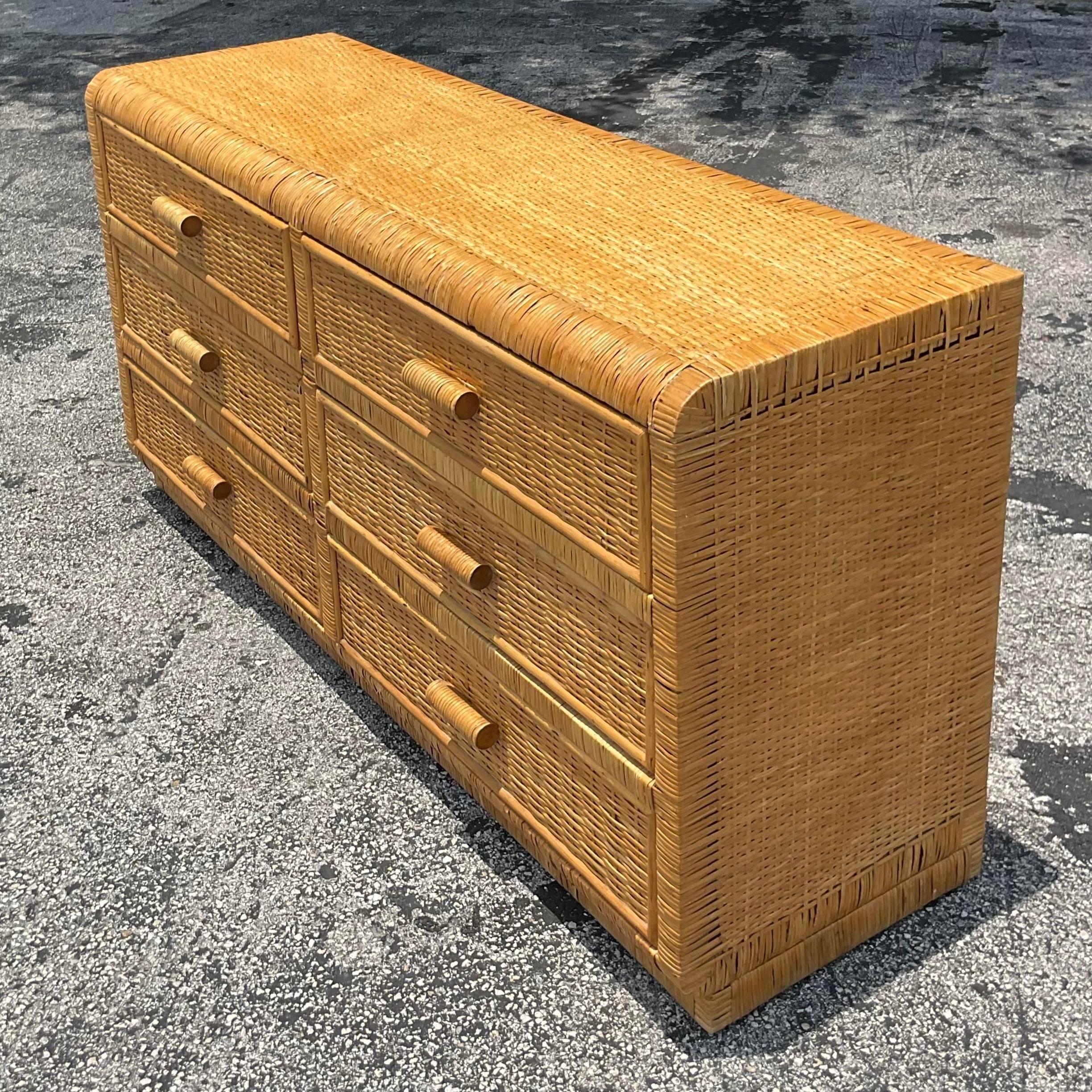 Enhance your home with the Vintage Coastal Woven Rattan Six Drawer Dresser. This American-style piece blends coastal charm with classic elegance, featuring six spacious drawers and intricate rattan detailing. Perfect for adding a touch of relaxed