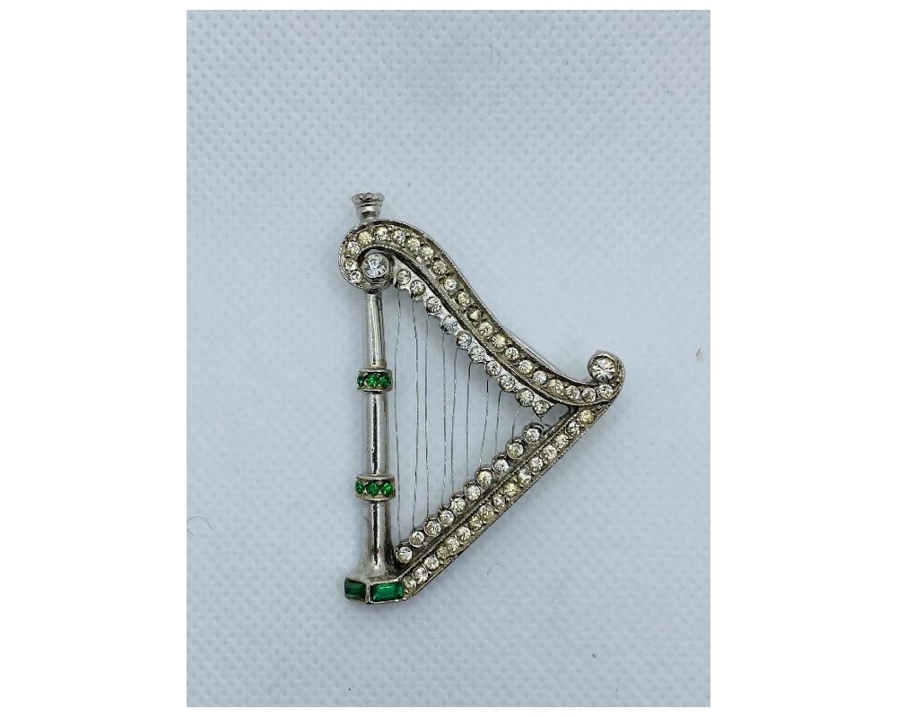 Vintage Costume Jewelry Harp Brooch with Rhinestone

This is in great condition large brooch

Condition is Consistent with age and use

with emerald like green and white rhinestones

size is approximately 2 ½ inches long by 1 ½ inches wide

Due to