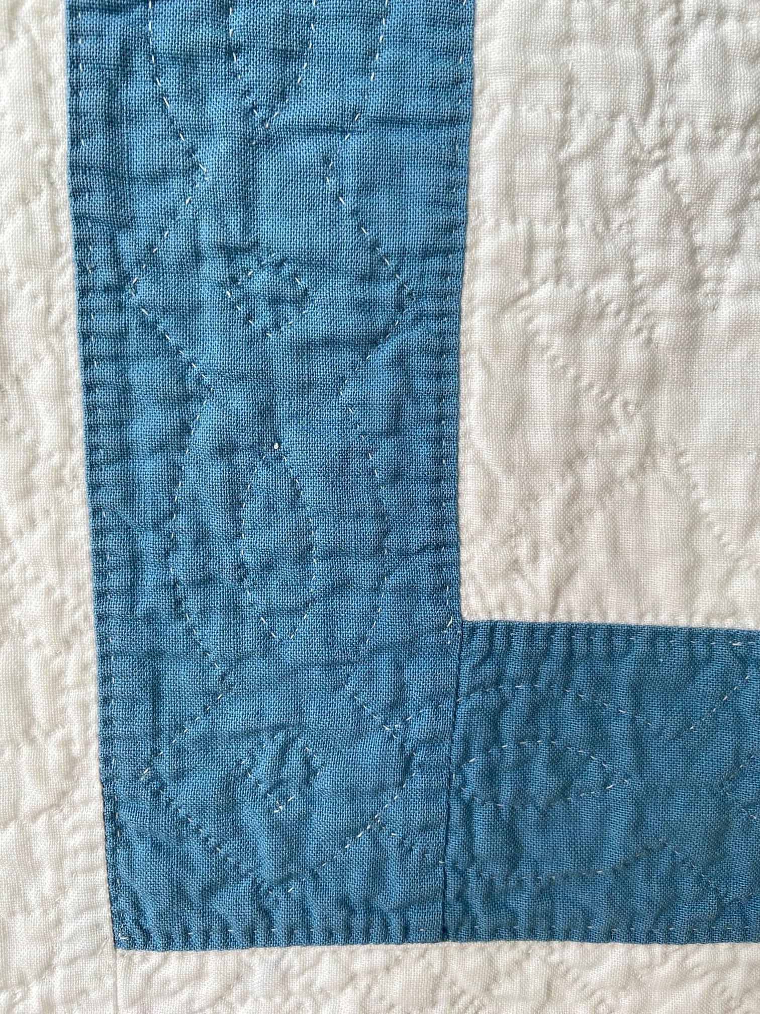 white quilt with blue stitching