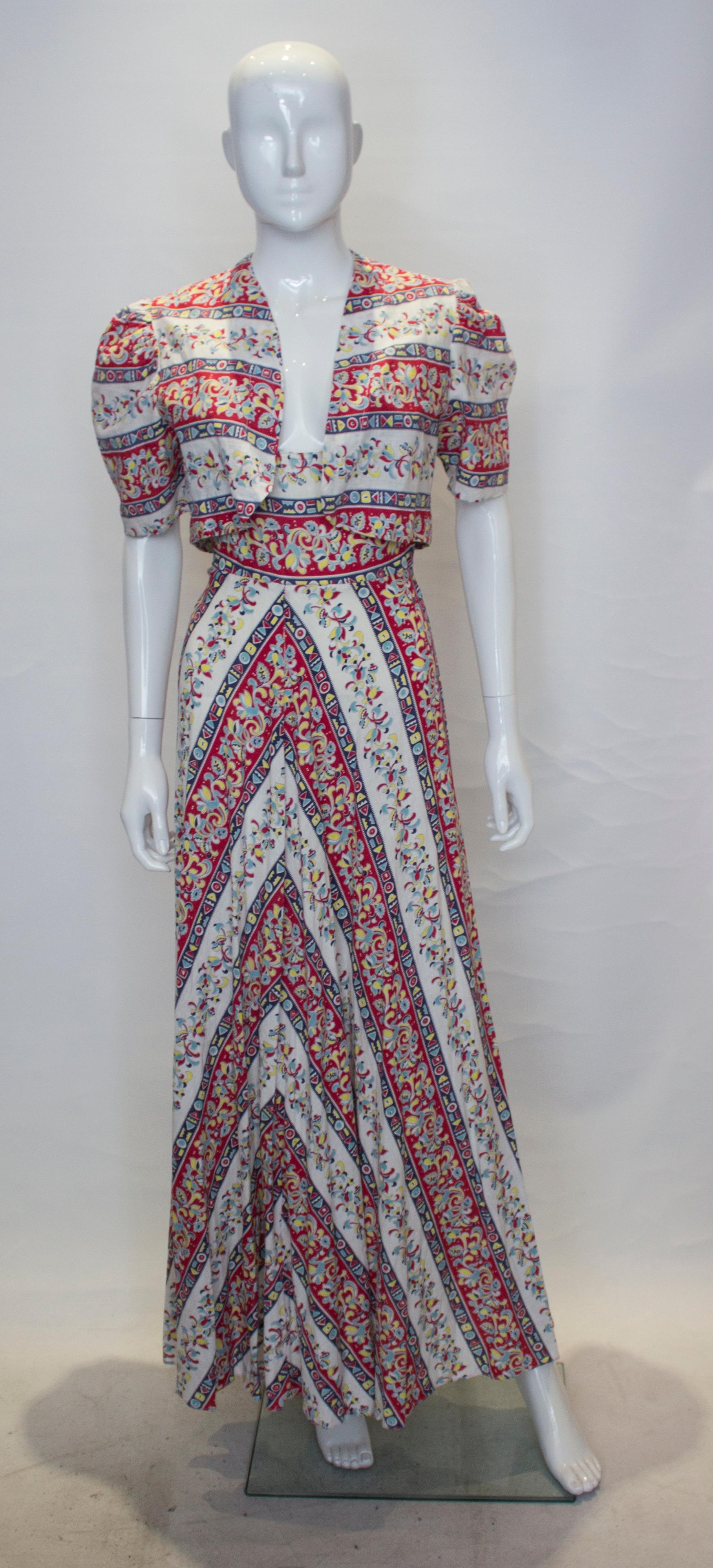 A pretty summer outfit, a long vintage cotton dress and matching bolero. The dress is in a pretty print in red, yellow and blue , has a scoop front and backline and self fabric belt.
Measurements; Dress Bust 36'', waist 29'',lenght 58''. Bolero bust