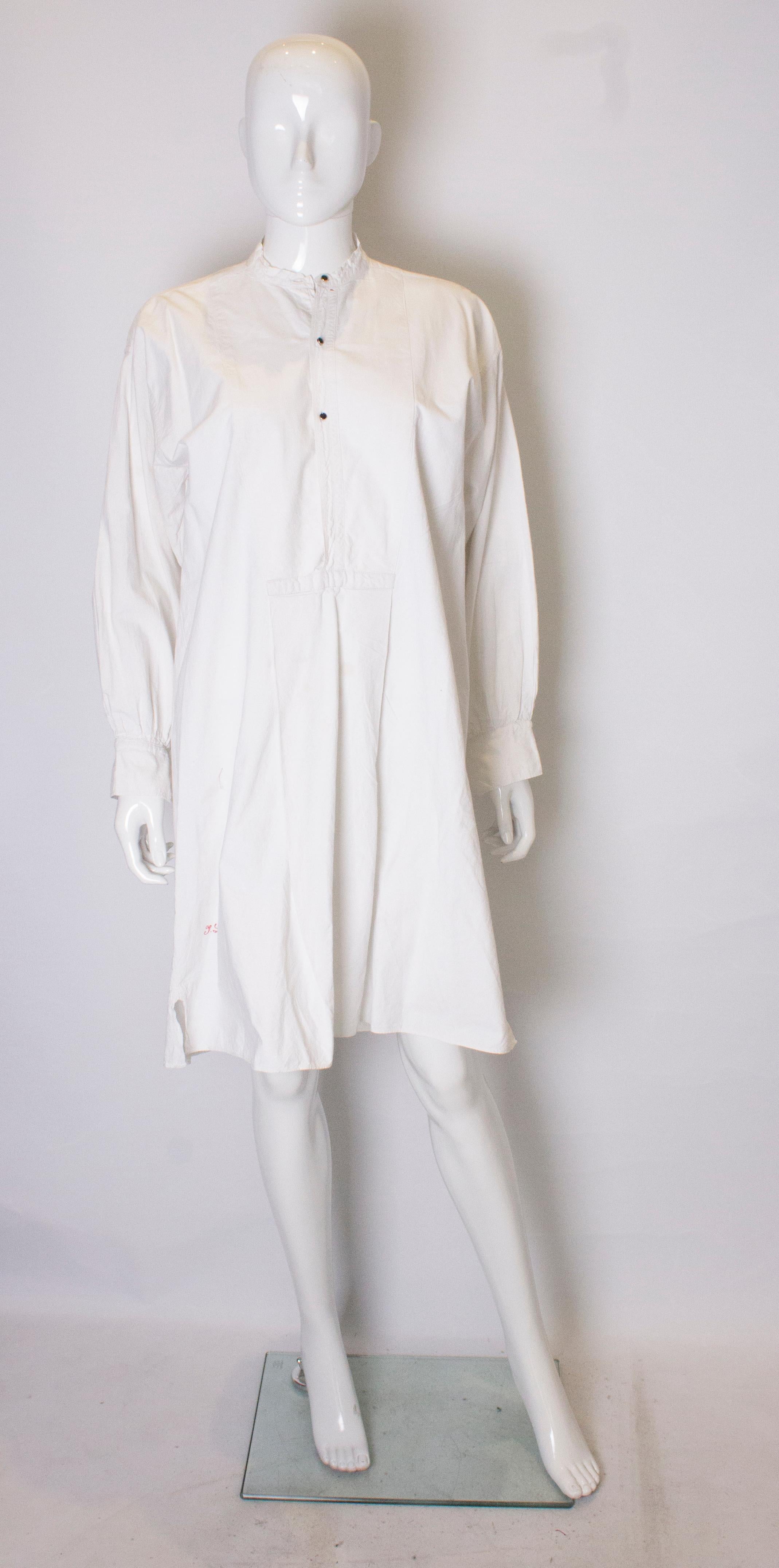 A lovely vintage heavweight cotton shirt dress. The dress has a stand up collar, single button cuffs and  a 4'' slit on either side.