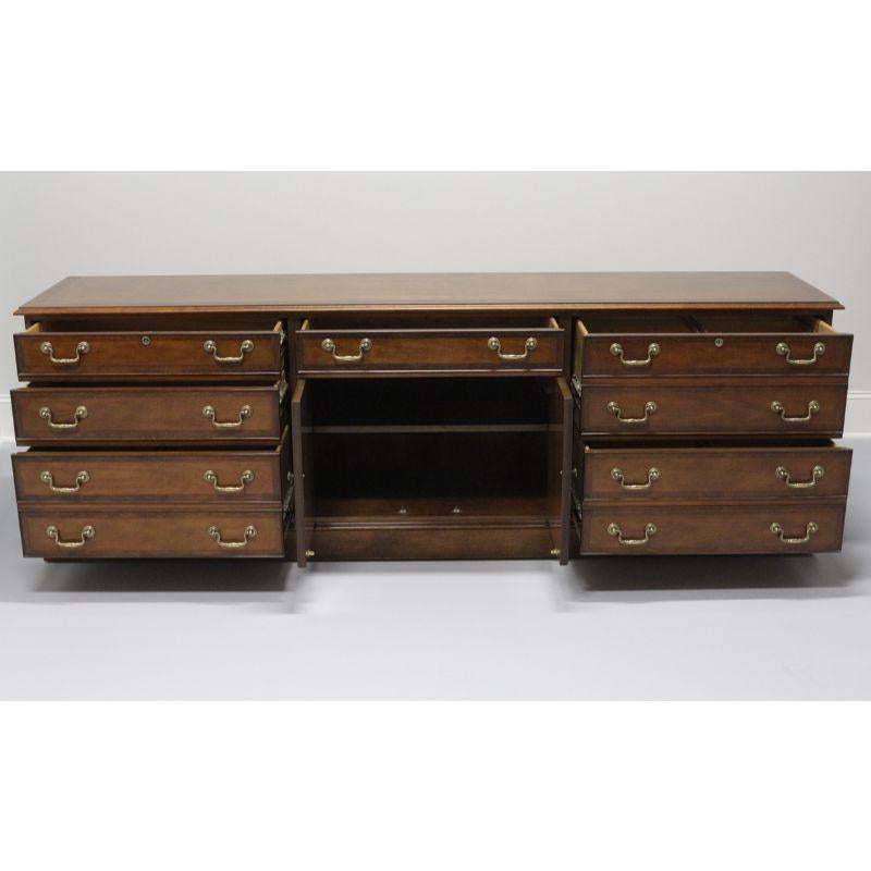 A Chippendale style executive file credenza by Councill. Banded burl walnut with brass hardware, made in the USA in the late 20th Century. Features three dovetailed desk drawers and three large file drawers on metal glide tracks. Side drawers lock