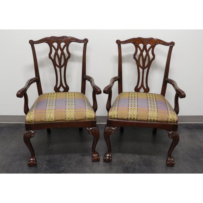 A pair of dining armchairs in the Chippendale style by Councill. Made in the late 20th Century. Solid Mahogany with carved back splat, cabriole legs with carved knees, and ball in claw feet.

Measures: overall: 26.5 W 22.5 D 39.5 H, seats: 22.5.W 18