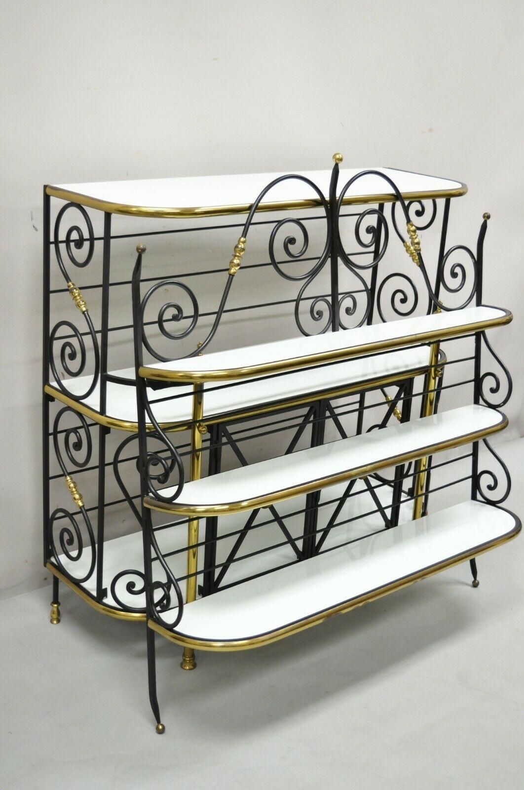 Vintage Country French Bakers rack wrought iron and brass, wall mount cabinet. Item features (1) wall hanging upper section, (1) free standing lower section, wrought iron construction, brass accents, white vitrolite milk glass graduating shelves, 2