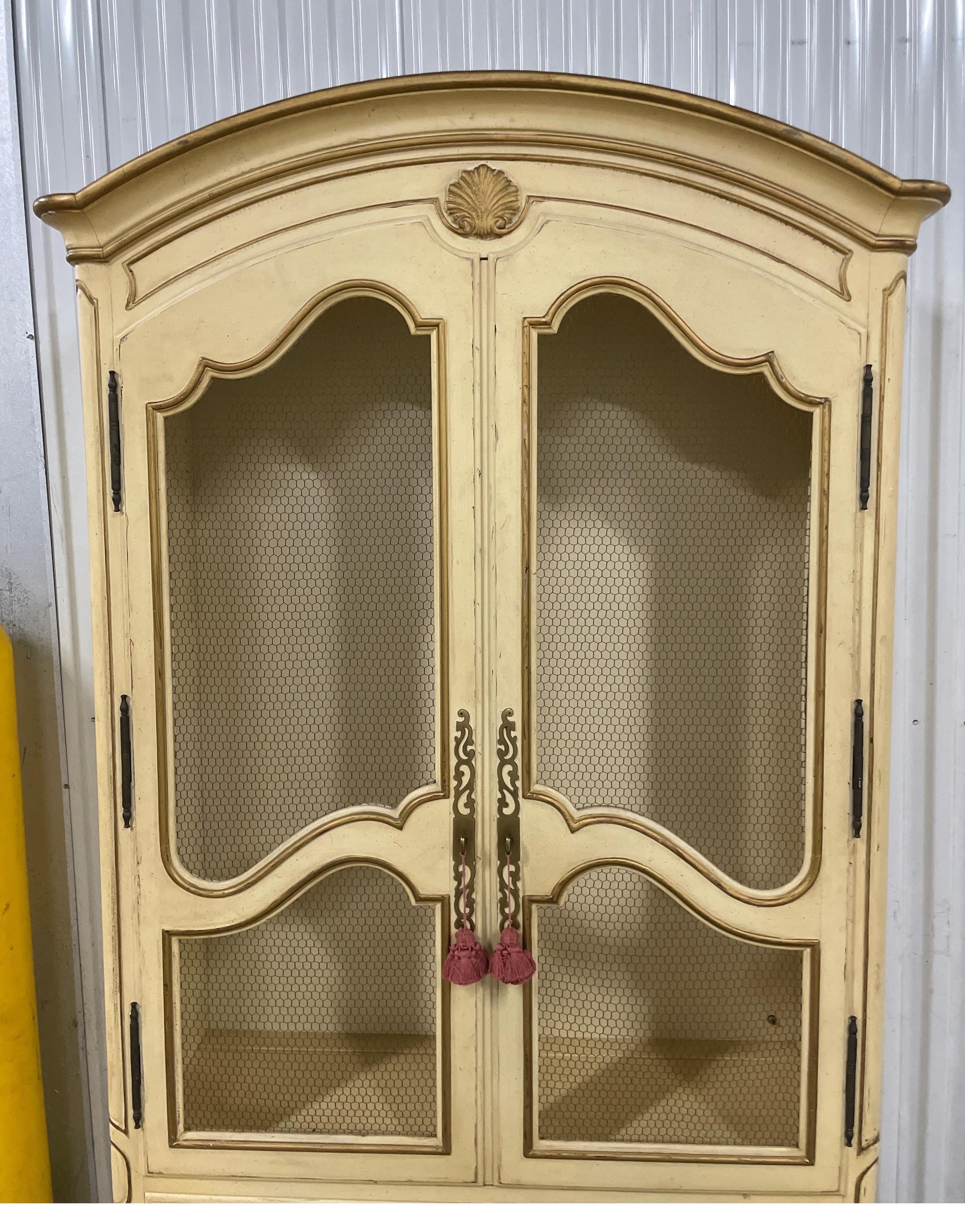 Vintage Henredon Country French Cabinet with chicken wire doors on top with three adjustable glass shelves. The bottom has two doors & an interior drawer for more storage.