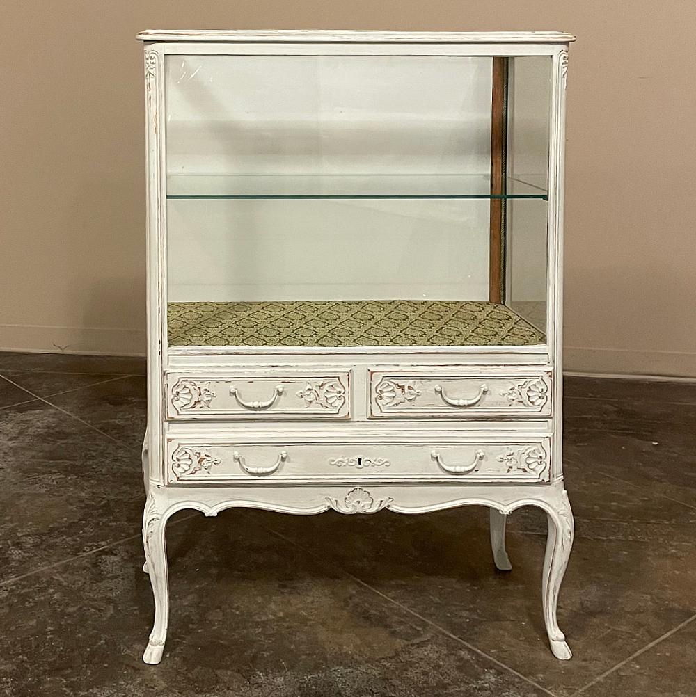 Vintage Country French Louis XV Painted Vitrine was designed to display your finest heirlooms on top and store fine linens or flatware below. Originally intended for the dining room, it is now a great choice for any room, including the family room