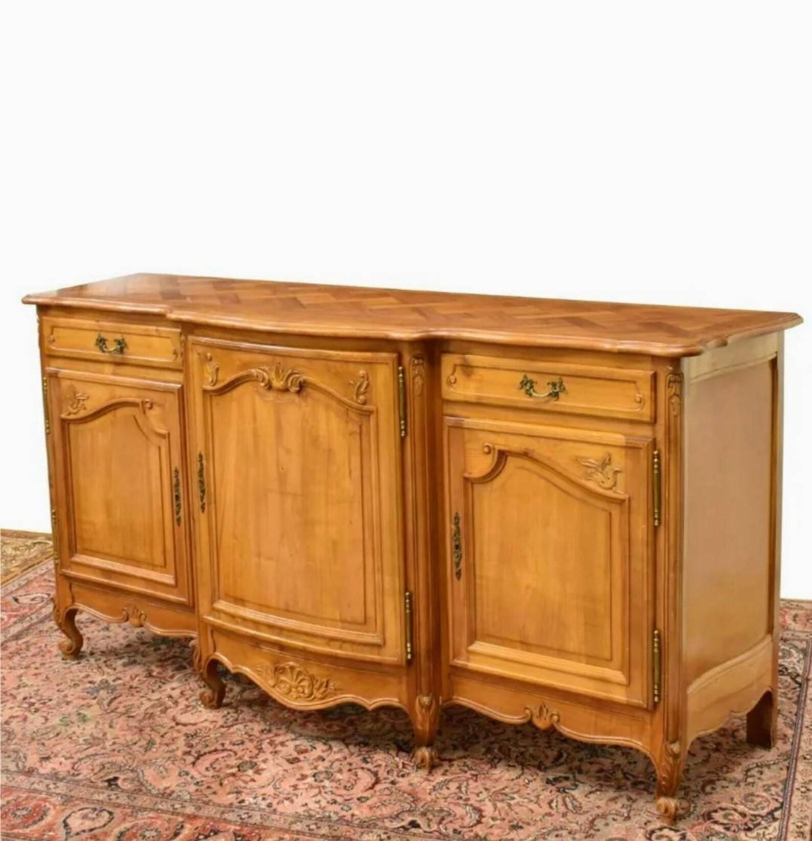 An exceptional vintage country French Louis XV style fruitwood breakfront sideboard.

Hand-crafted in France during the first half of the 20th century, featuring an elegant and sophisticated parquetry-work top with elaborate serpentine shaped