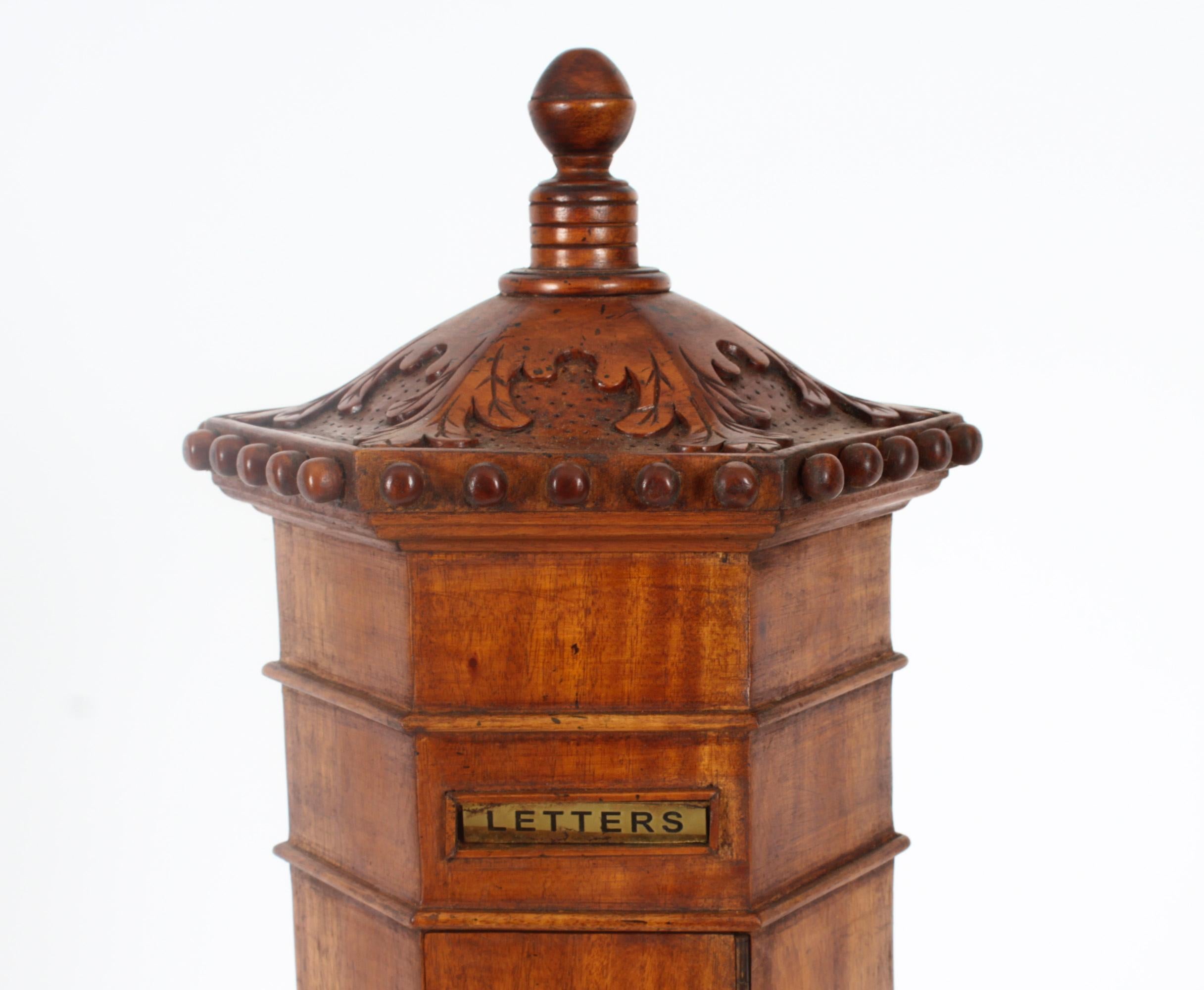 This is a beautiful vintage Country House Pillar Post Letter Box cabinet, dating from the second half of the 20th century.

The hexagon shaped solid walnut country house pillar post letter box features a superbly hand carved domed pagoda top with