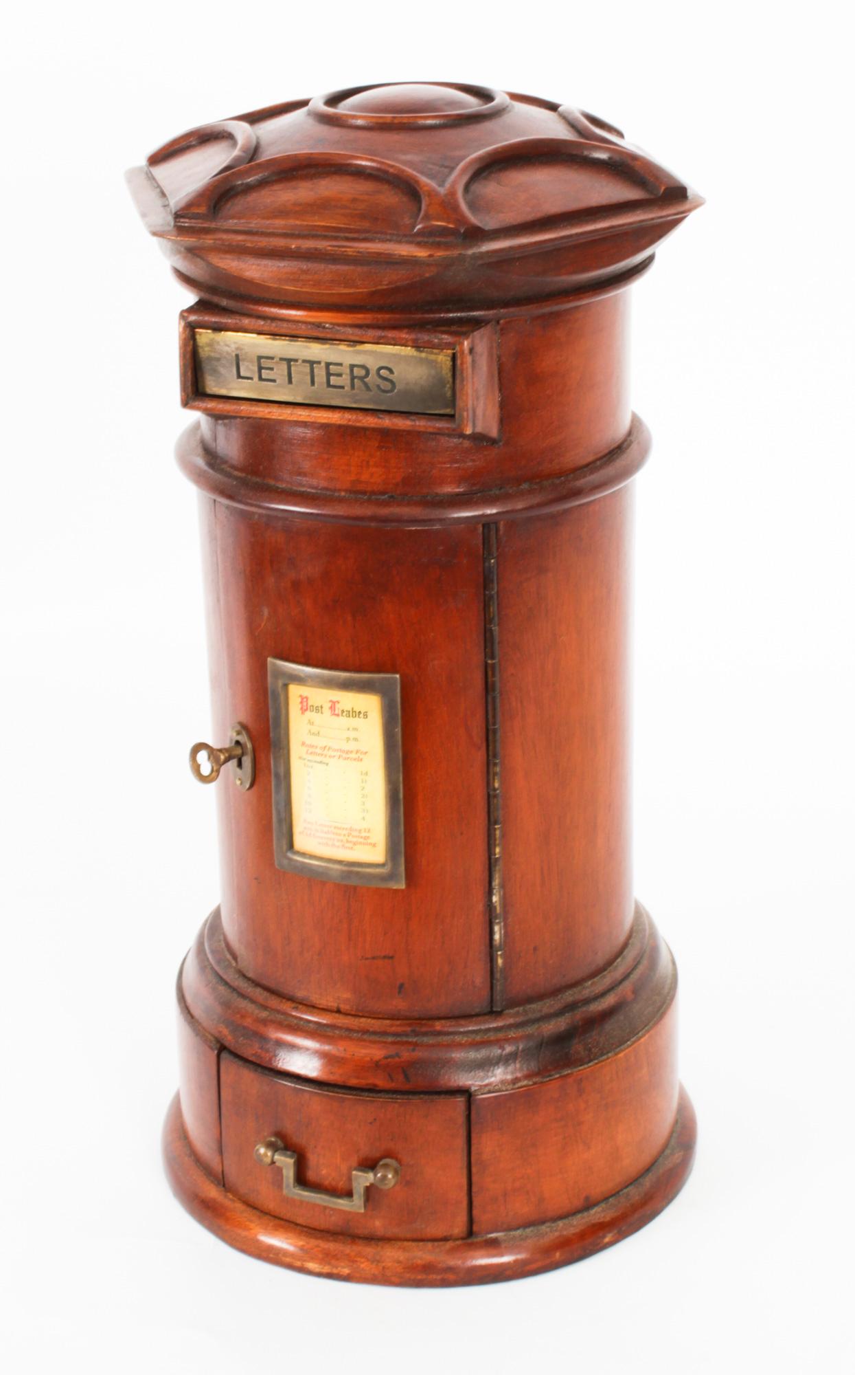 This is a beautiful vintage Country House Pillar Post Letter Box, dating from the second half of the 20th century.

The solid walnut country house pillar post letter box is cylinder shaped and features a hexagonal shaped top with a brass posting