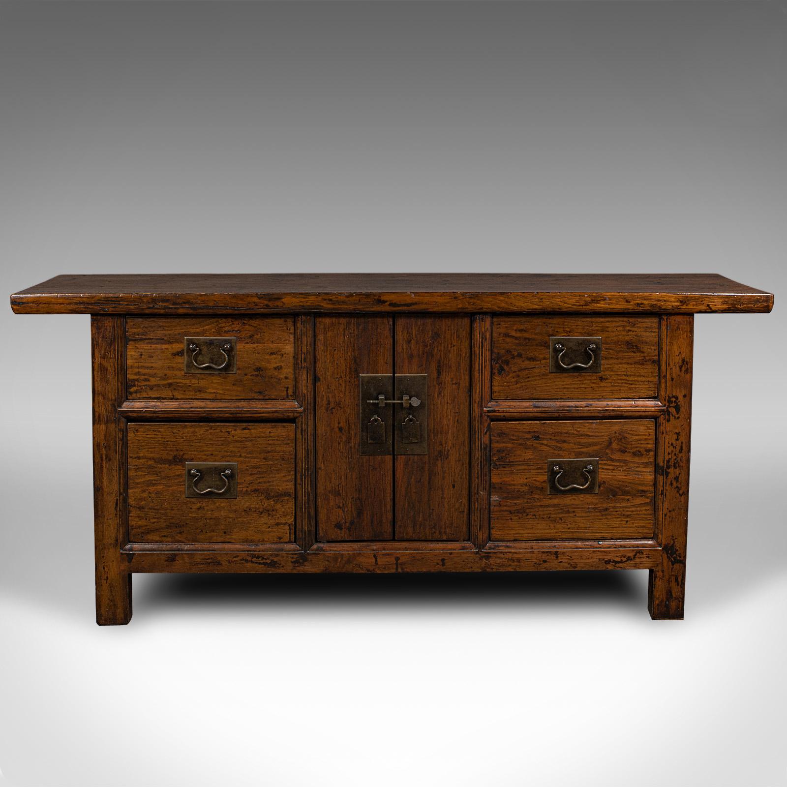 This is a vintage country house sideboard. An Oriental, Chinese elm side cabinet, dating to the mid 20th century, circa 1960.

Pleasingly robust and offering useful storage
Displays a desirable aged patina throughout
Chinese elm presents dark