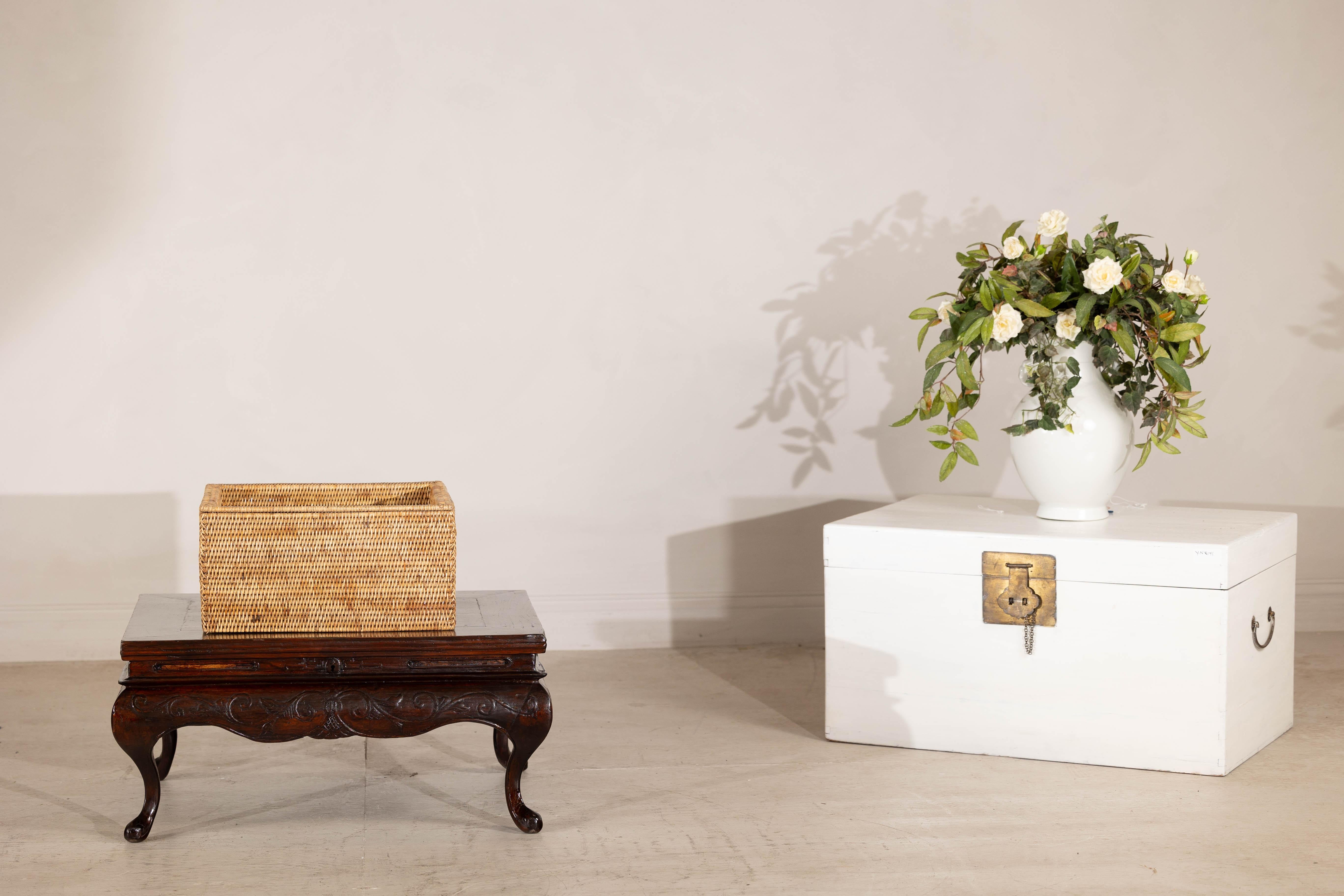 This vintage rectangular lidded rattan box brings an air of rustic charm to any home. Expertly handwoven, its tightly constructed design showcases intricate craftsmanship while offering both durability and visual texture. The rich honey-toned rattan