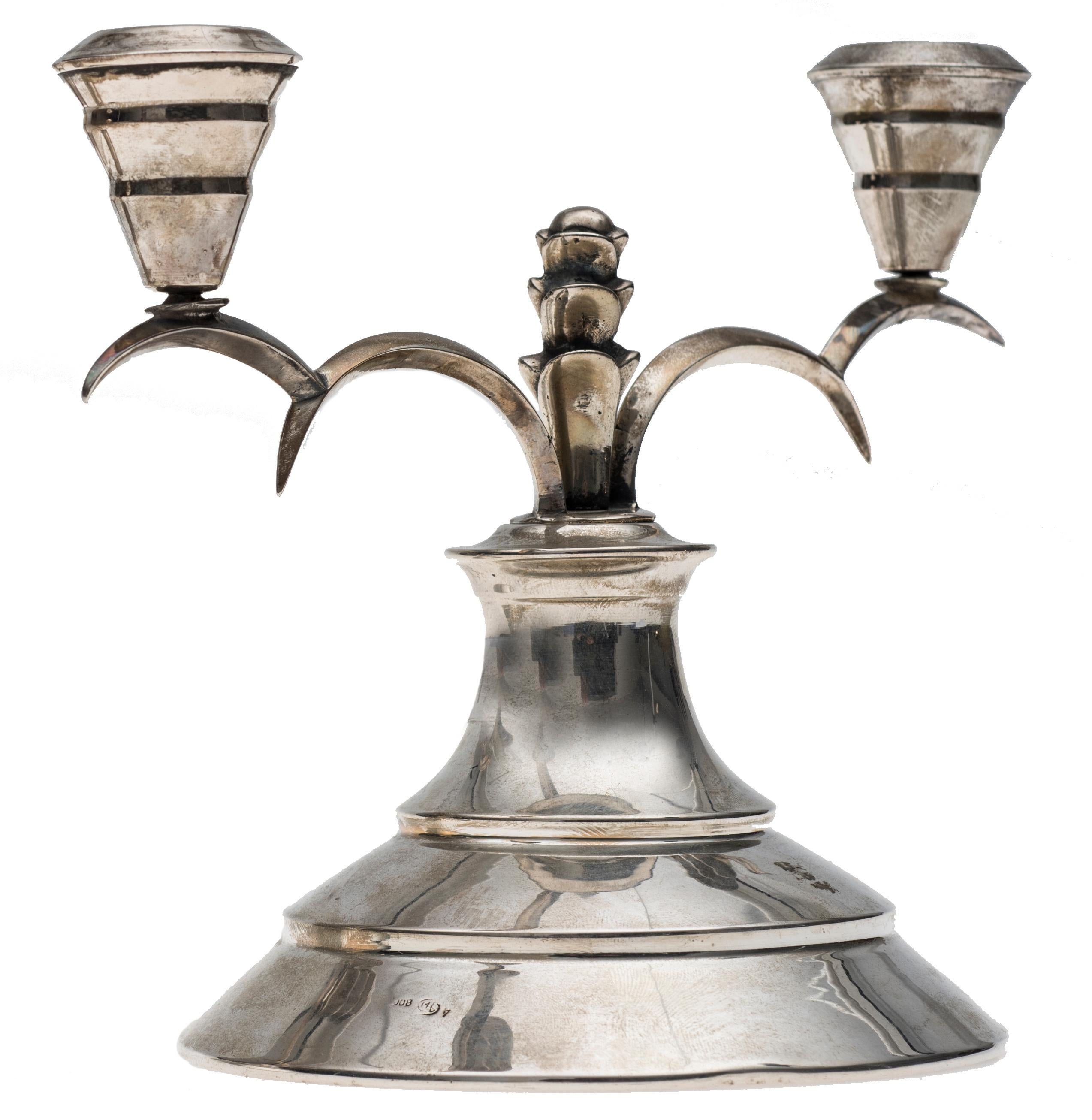 Vintage pair of silver deco candleholders, Italian manufacture beginning of 1900.
Smoot body, shaped arms decorated with vegetal motives.
Good conditions.

This object is shipped from Italy. Under existing legislation, any object in Italy created