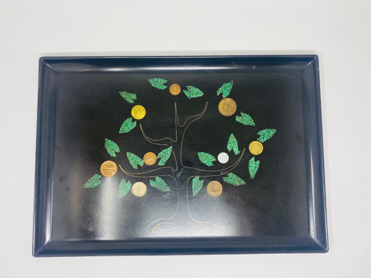 Mid-Century Modern money tree tray by Couroc Monterey California. These serving pieces are handmade by Master Crossman‘s, made from Shell, coins, wood and metals fused into a satin black resin base. This beautiful piece displays a tree design with