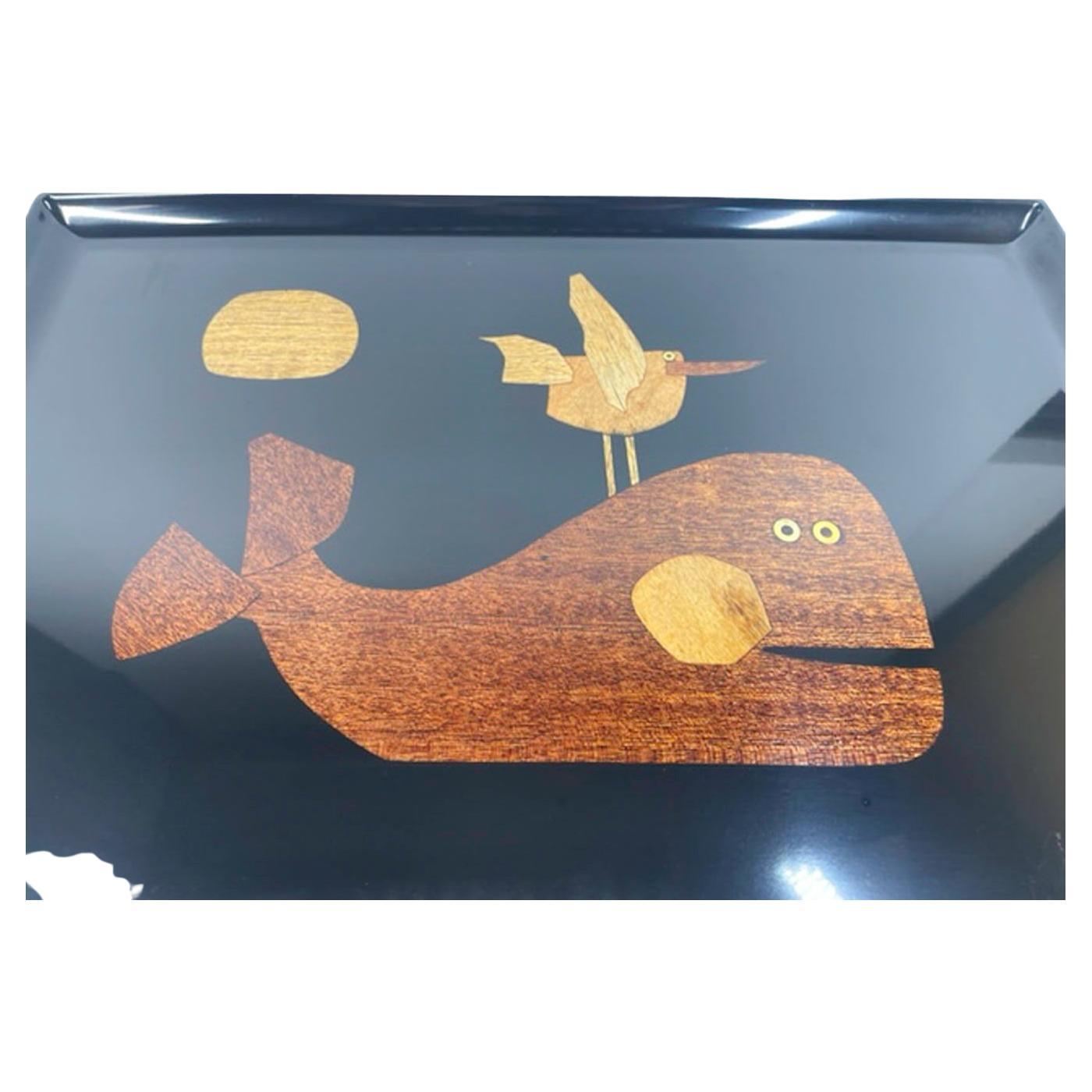Vintage tray by Couroc of Monterey, made of wood inlaid phenolic resin depicting a whale with a shorebird on its back and with the sun above. Phenolic resin was used for its resistance to damage from cigarette burns, alcohol and boiling water. This