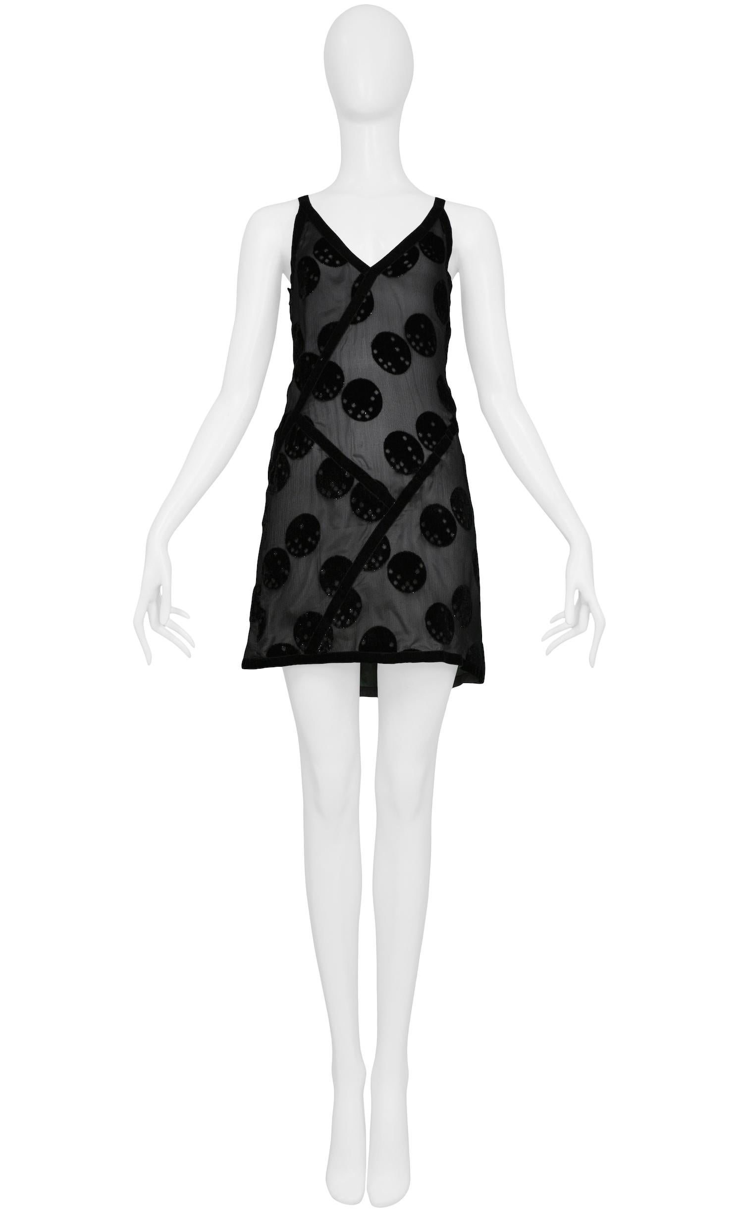 Vintage Andres Courreges silver mini slip dress with black chiffon overlay. The dress features a v-neckline, polka dot velvet burnout design throughout, and patchwork-style velvet trim detail. Side zipper closure as well as hook and eye closure at
