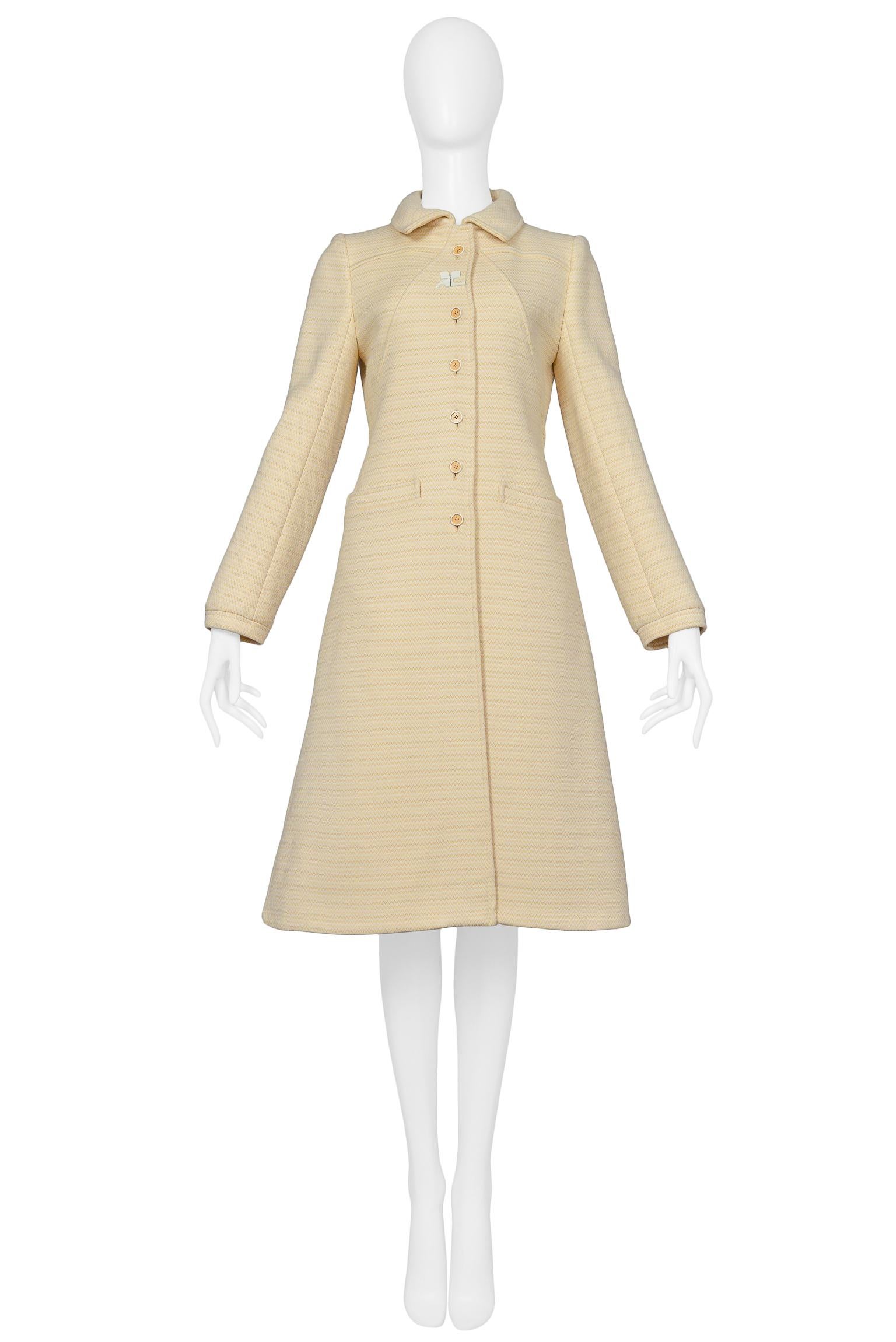 Vintage Andre Courreges peach & cream wool collared winter coat with defined yoke, front welt pockets, button front closure and white Courreges logo at neckline.
Please inquire for additional images.

Excellent Vintage